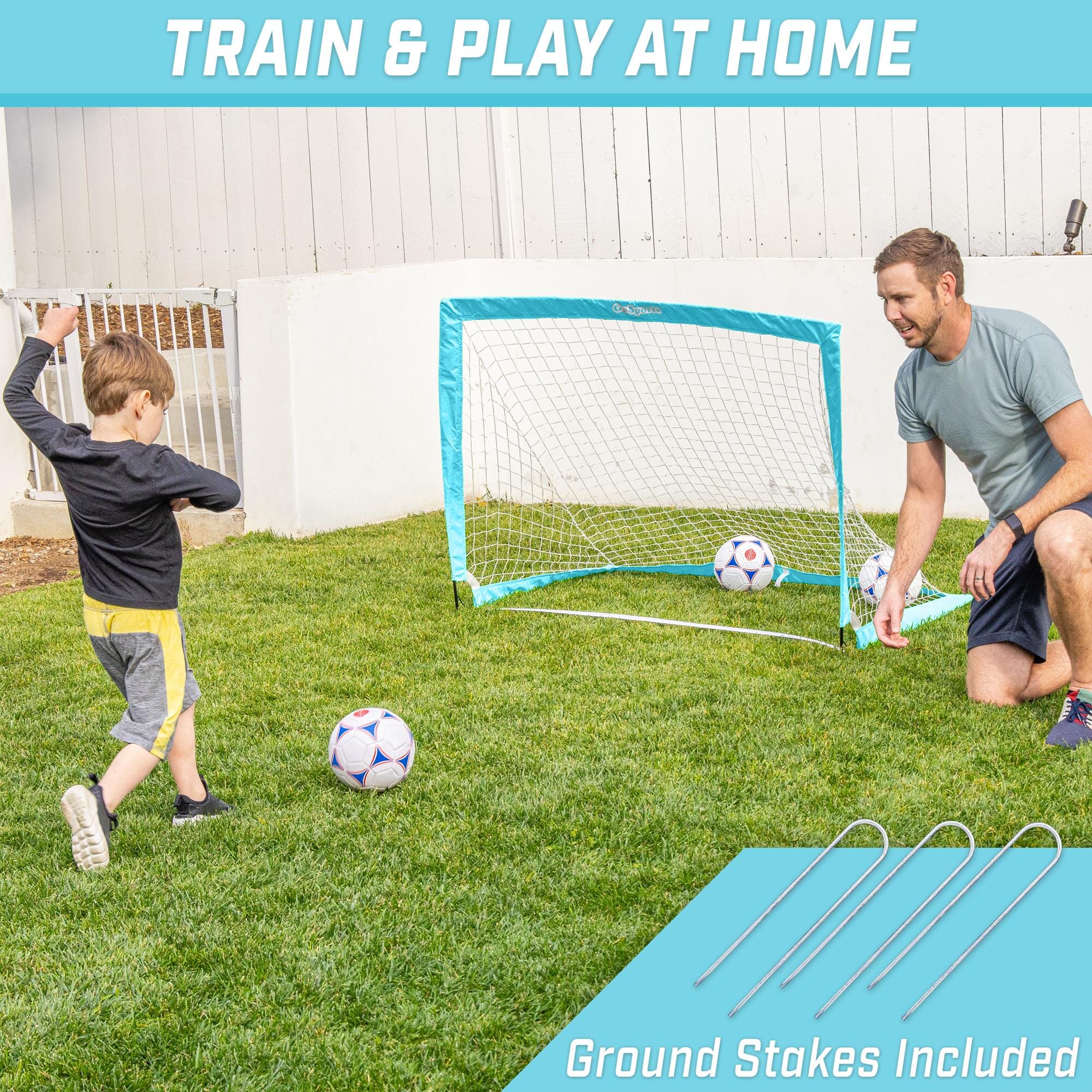 a man and a young boy playing soccer in the yard