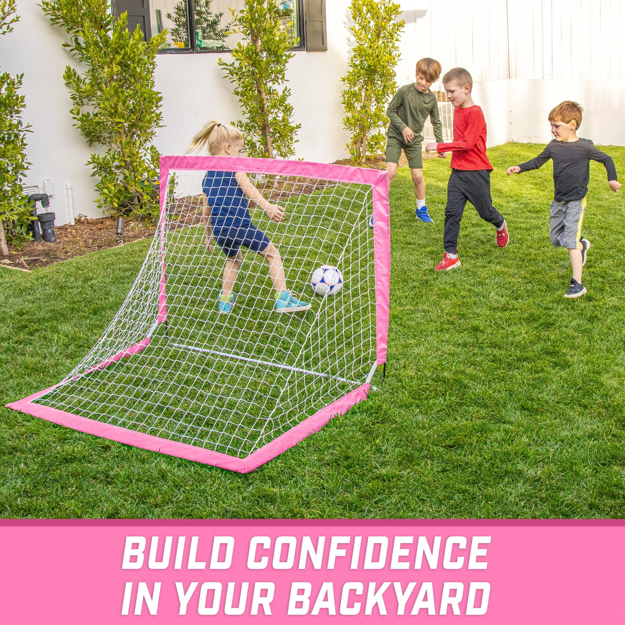 a backyard soccer goal with two kids playing in it