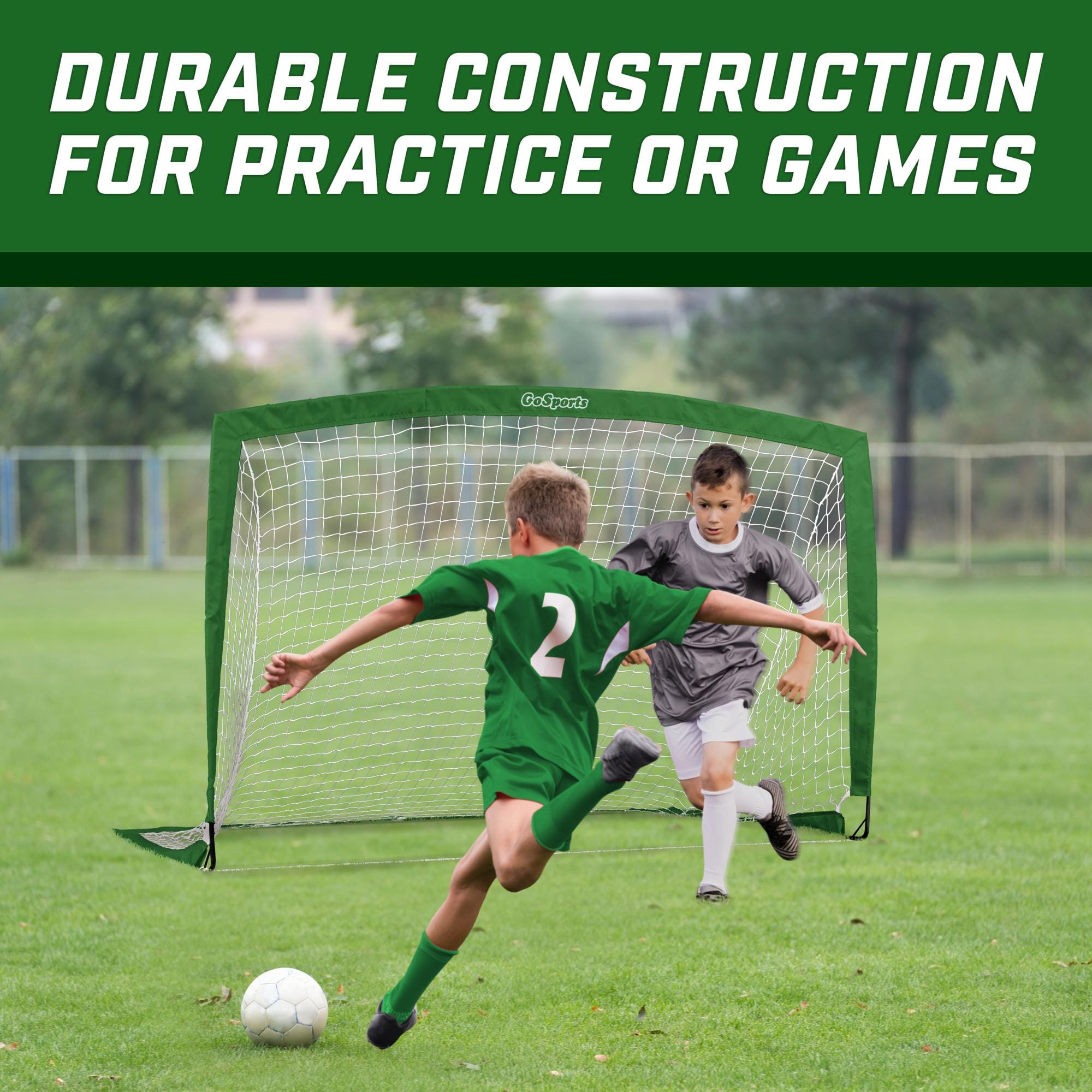 a young boy kicking a soccer ball in a field