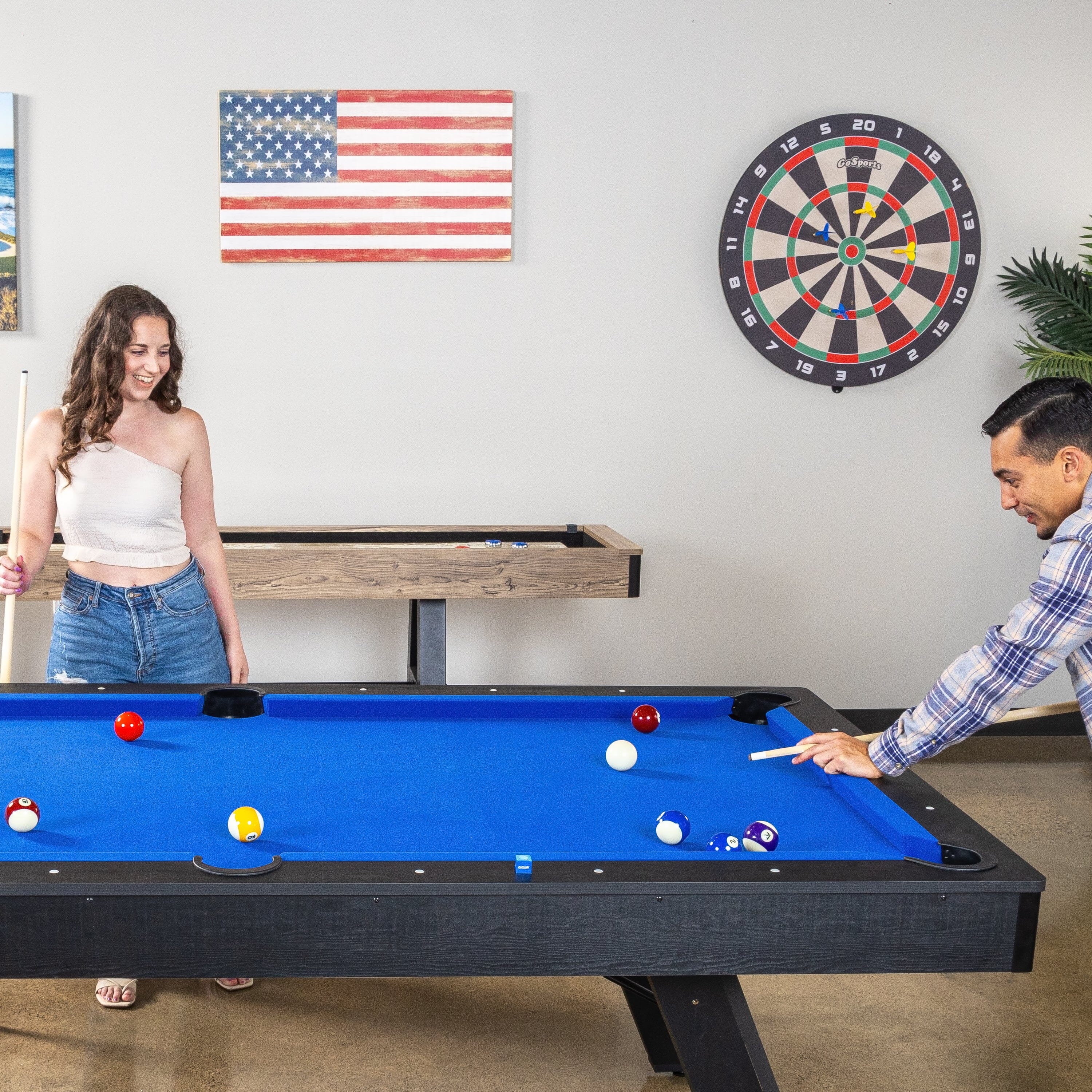 a man and woman playing a game of pool