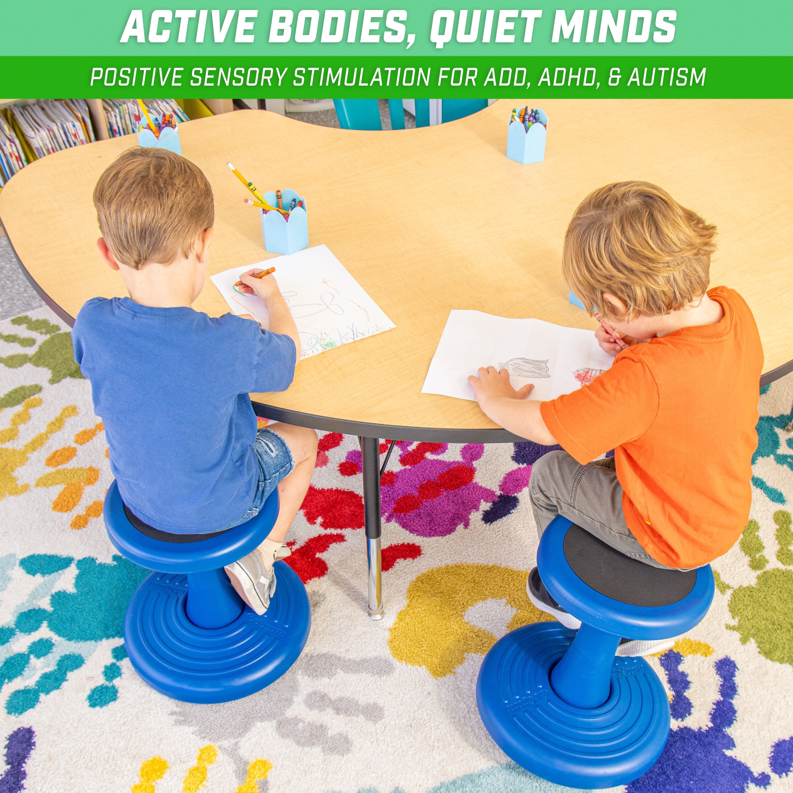 two children sitting at a table with a book