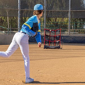 a young boy is playing baseball on a field