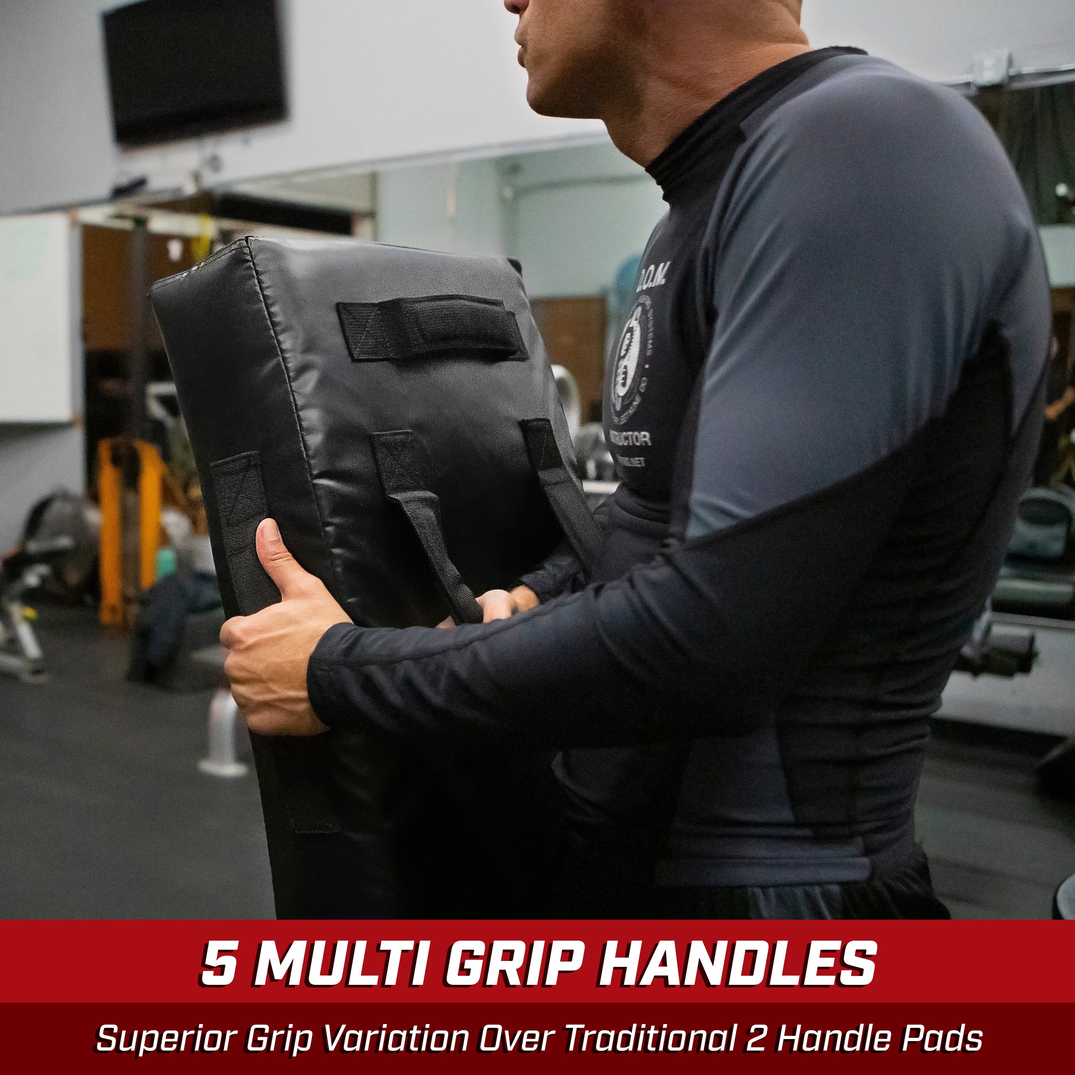 a man holding a pair of black gloves