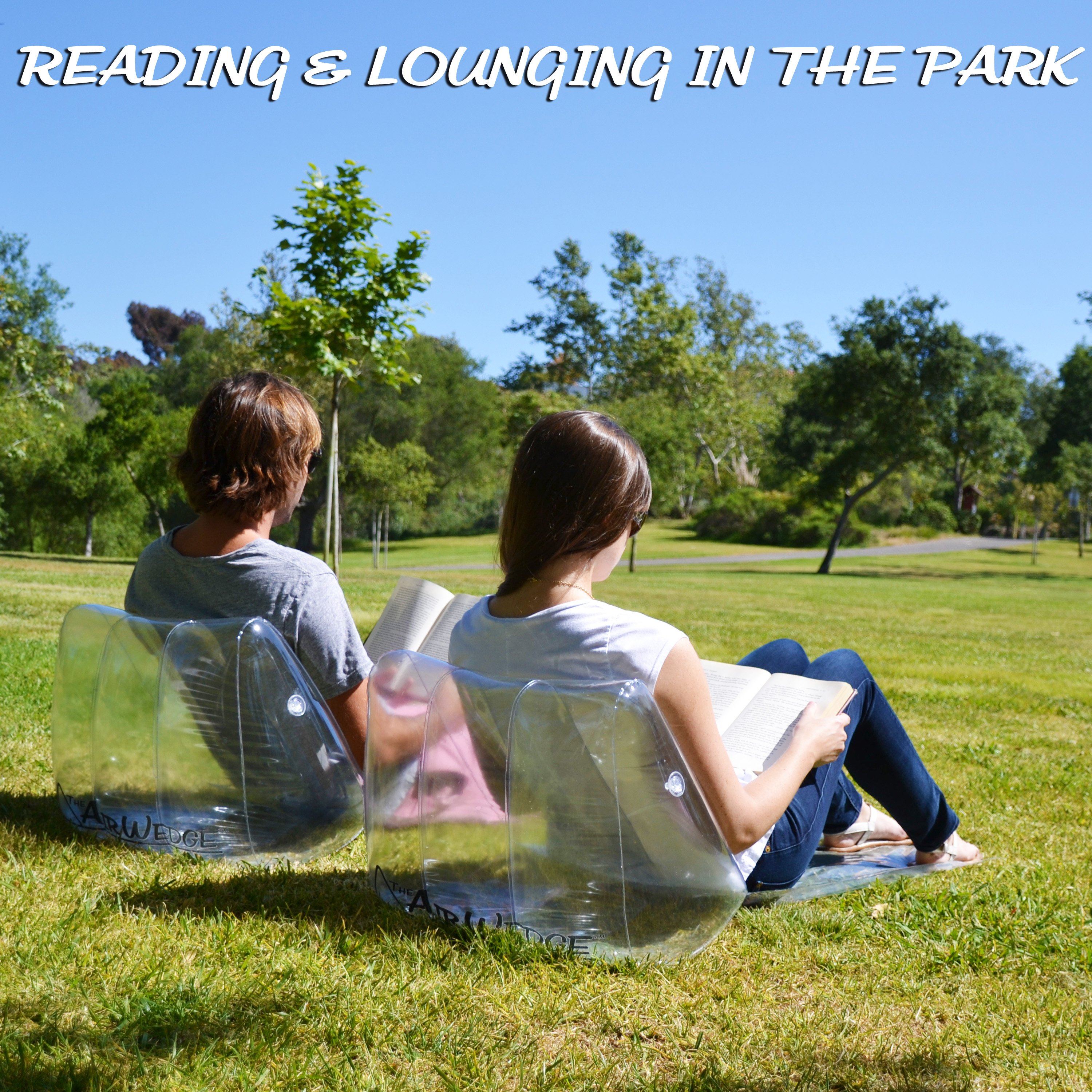 two people sitting on the grass