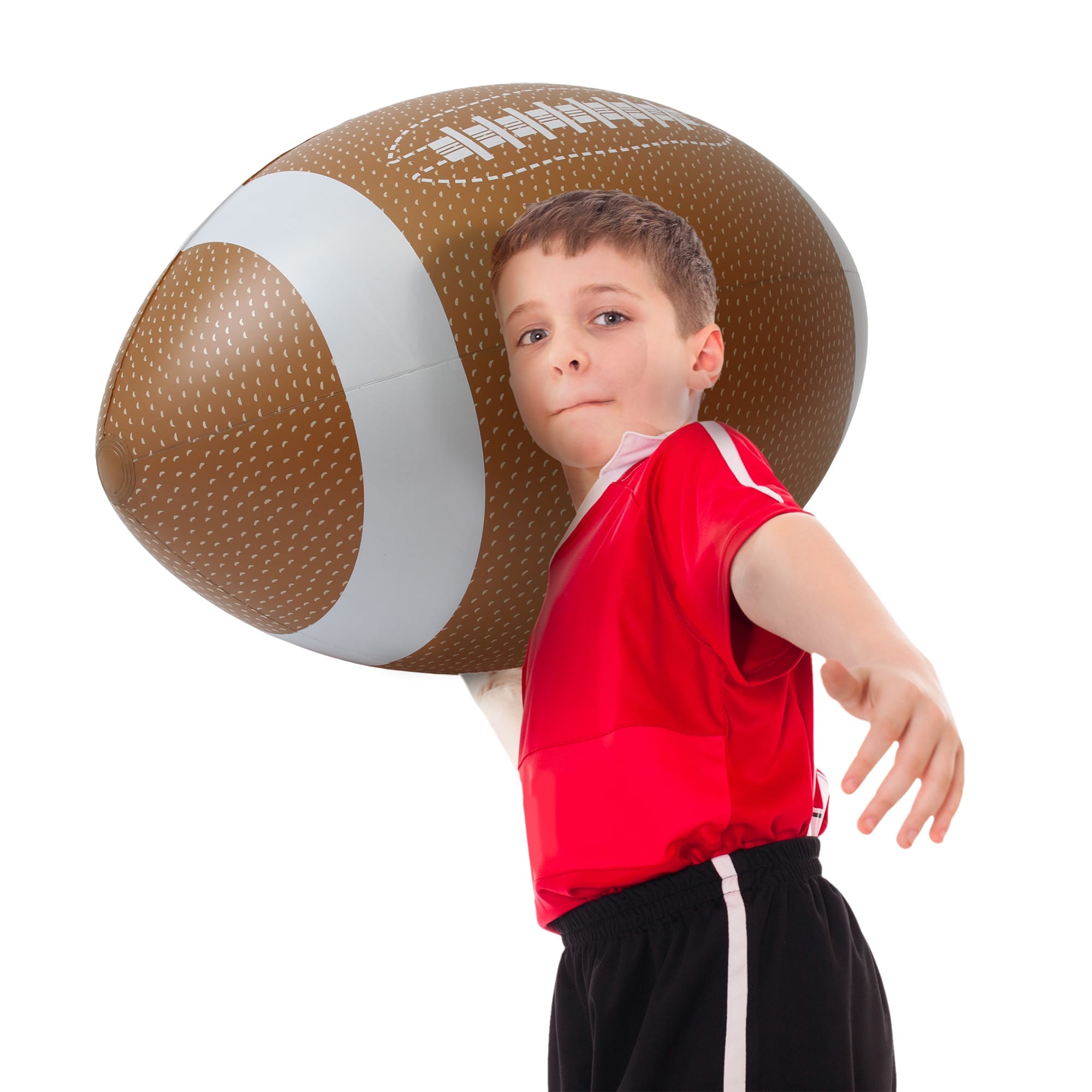 a young boy holding a football ball