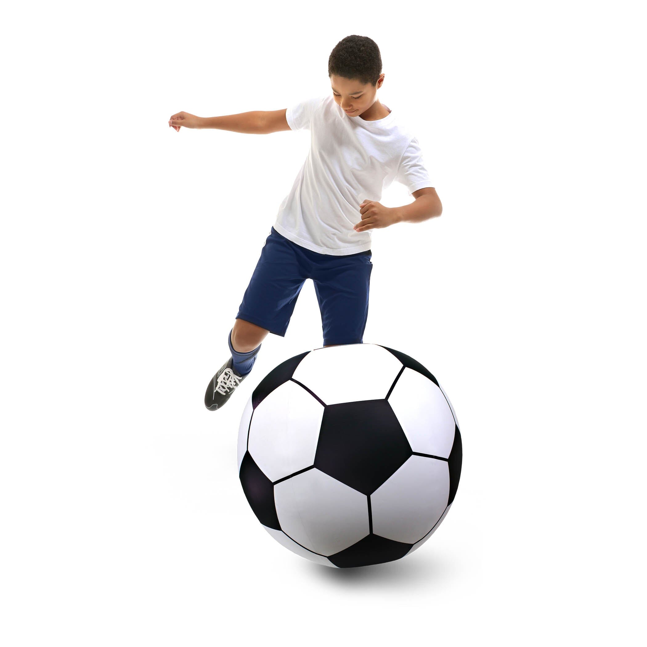 a young boy kicking a soccer ball