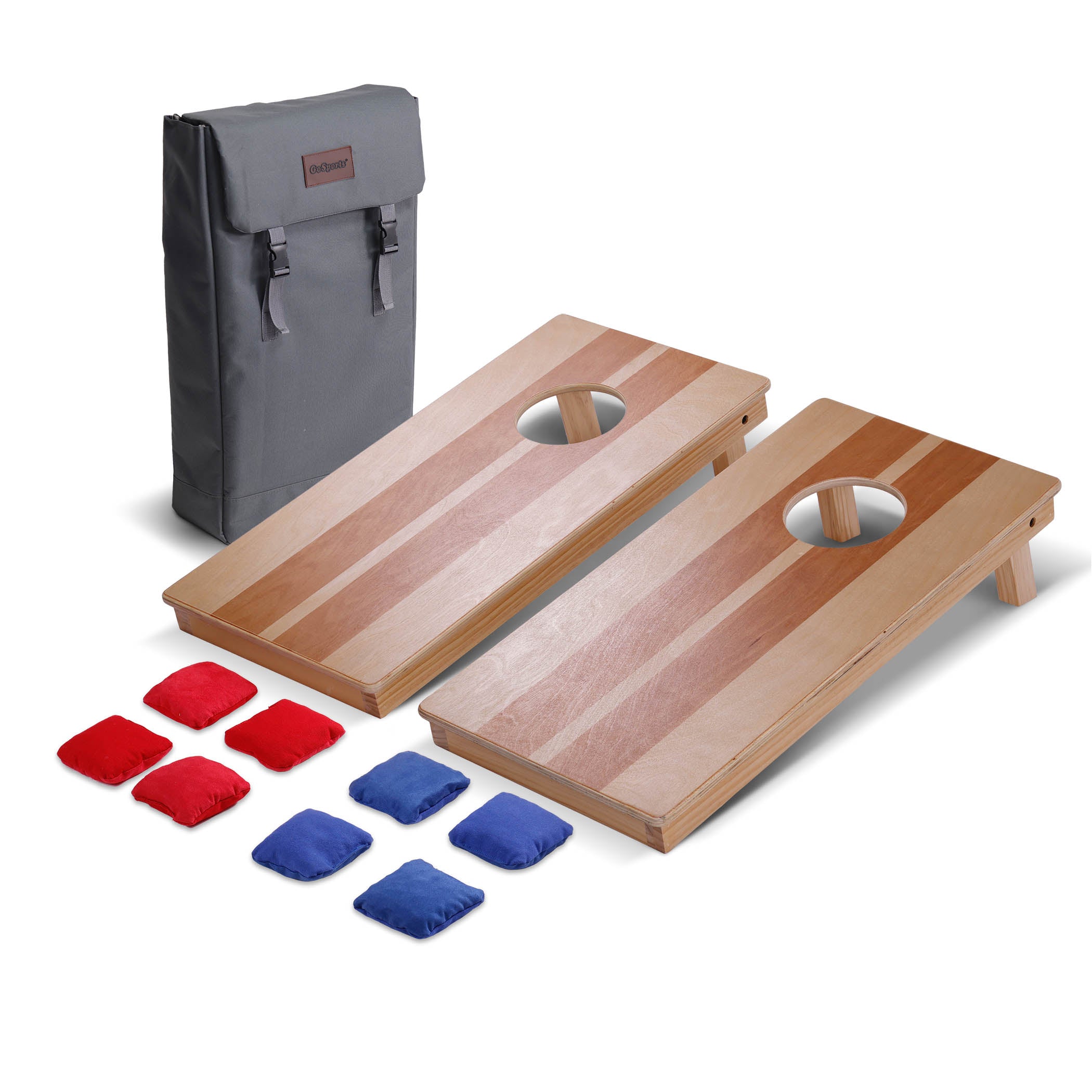 a wooden cornhole set with eight red and blue bean bags and gray backpack