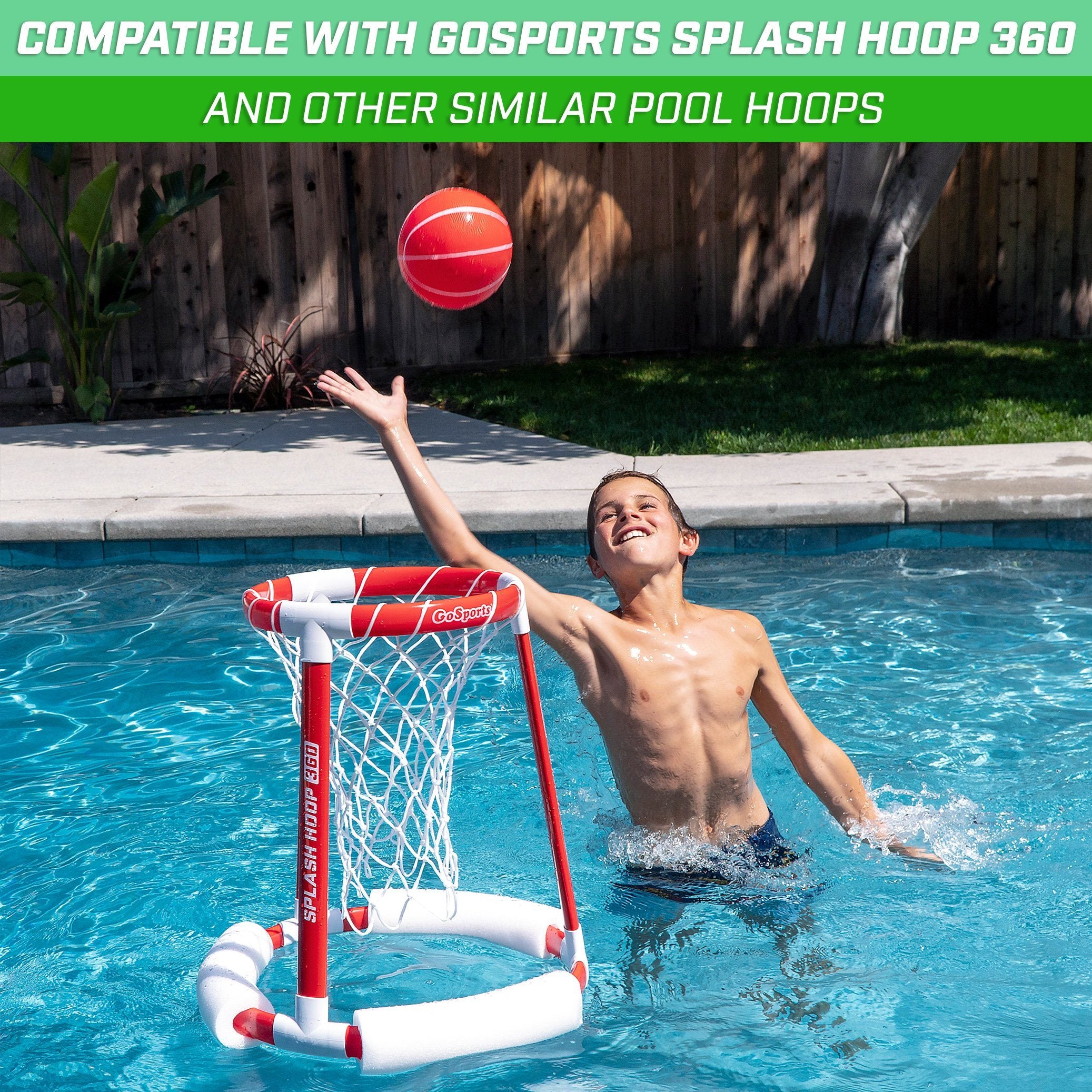 a boy playing with a basketball ball in a pool