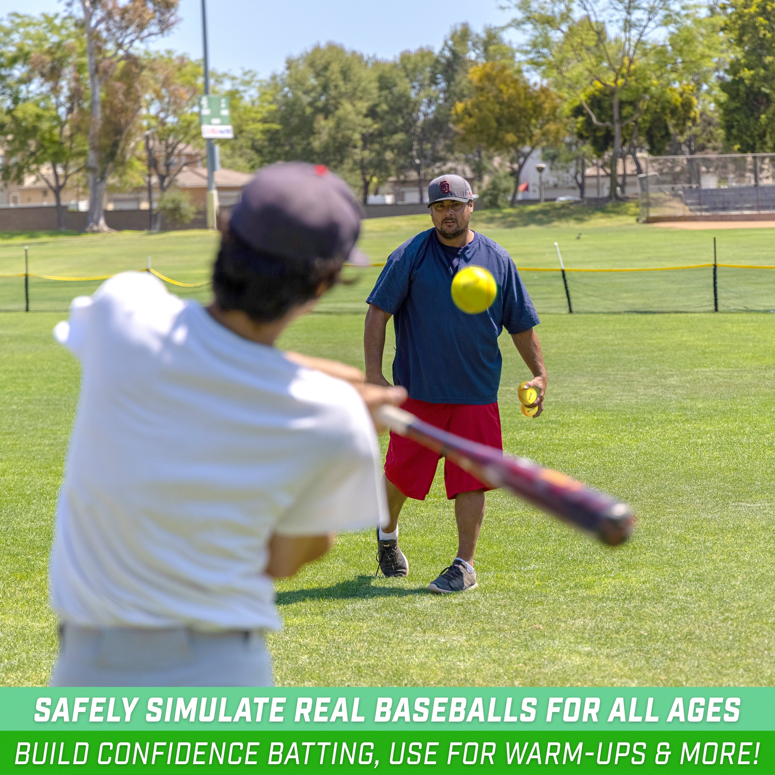 a man holding a yellow ball and a yellow bat