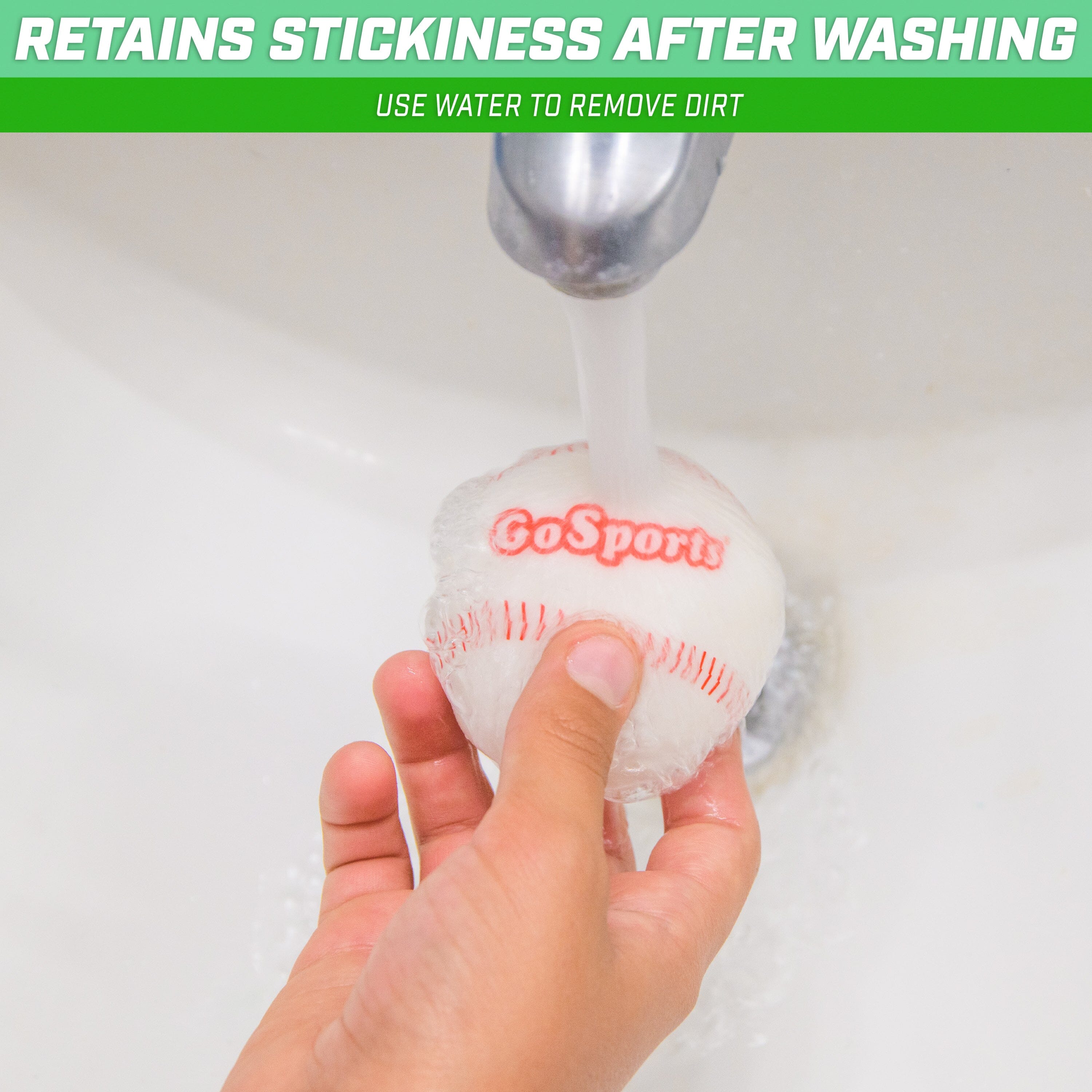 a person washing a baseball in a sink