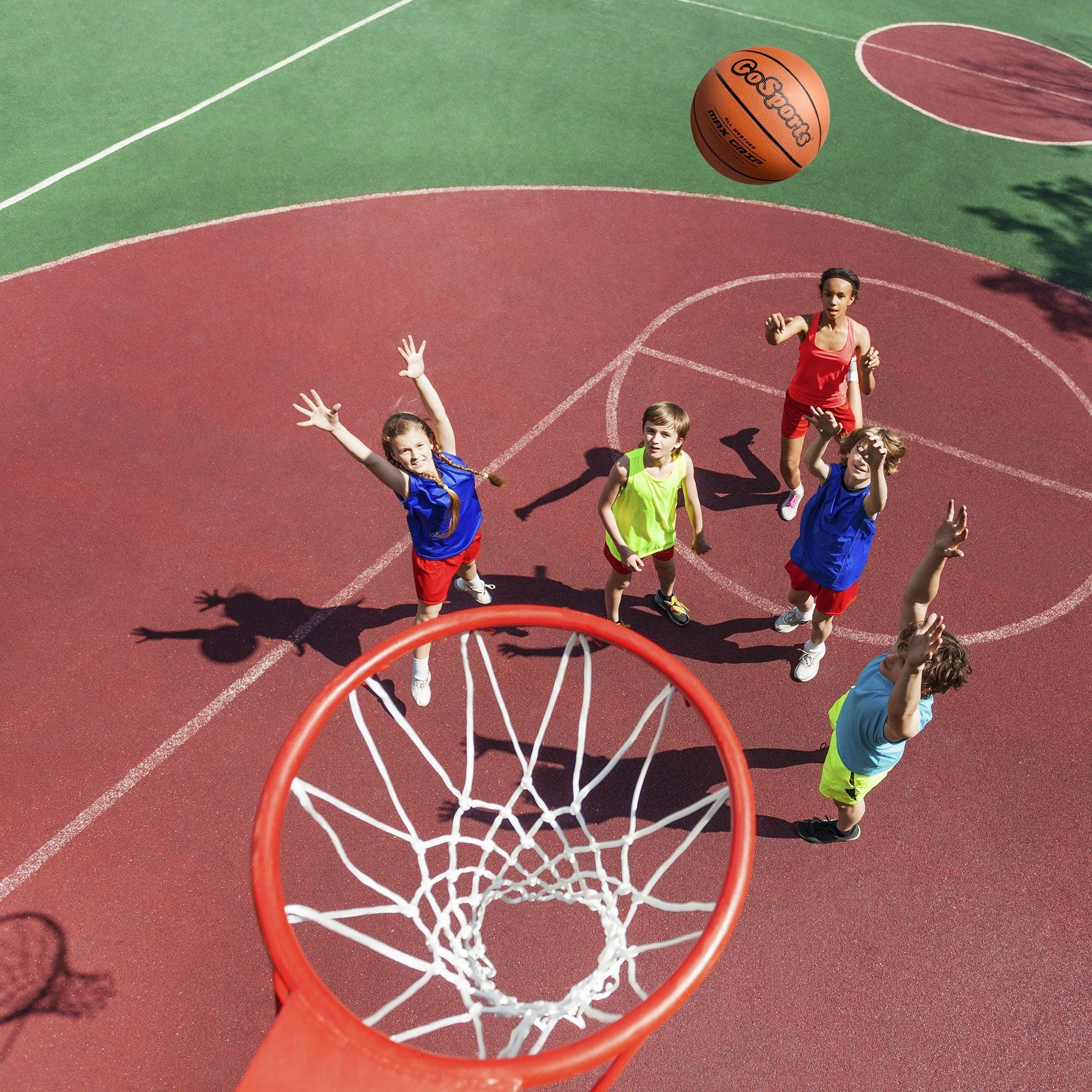 a group of kids playing basketball on a court