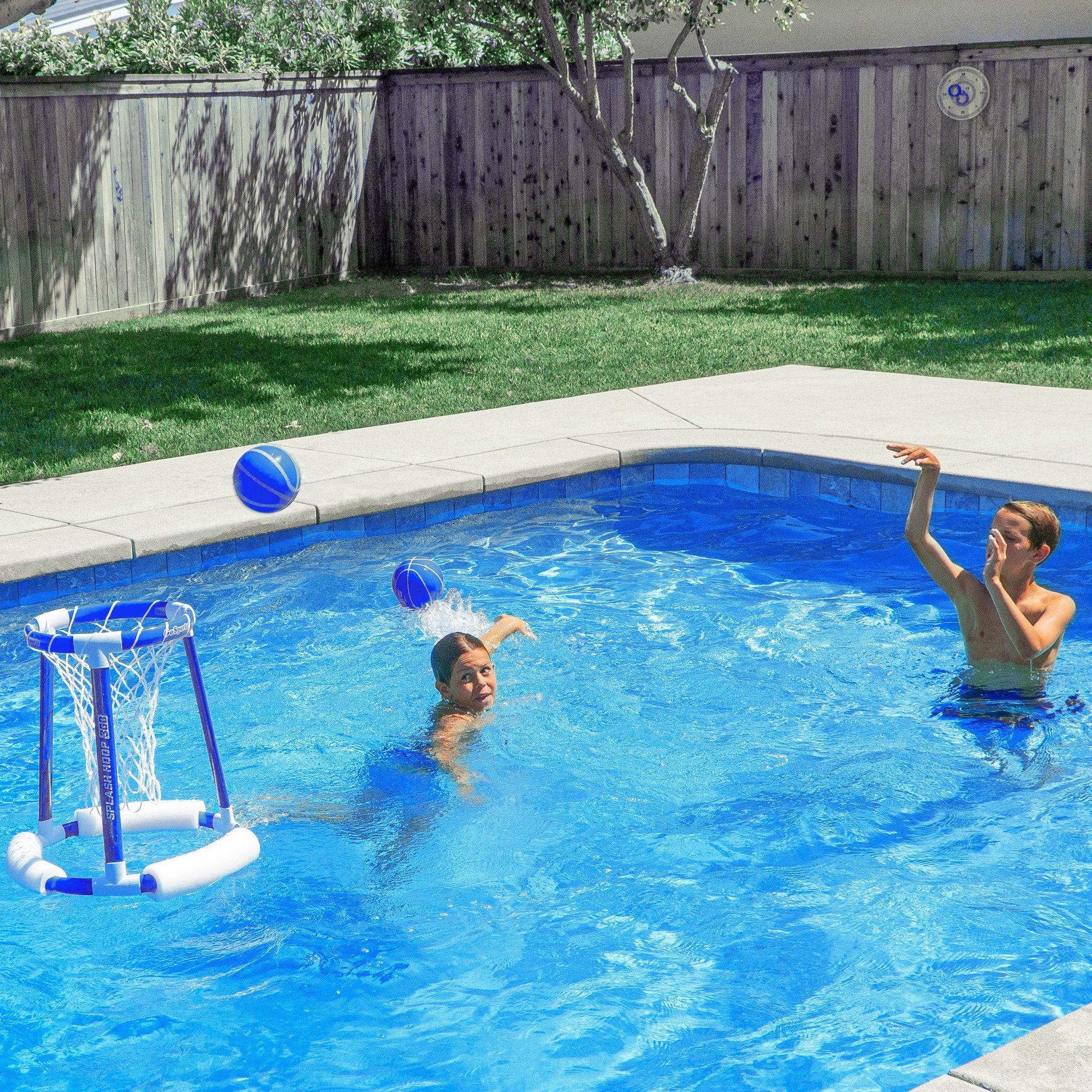 a couple of people playing in a pool