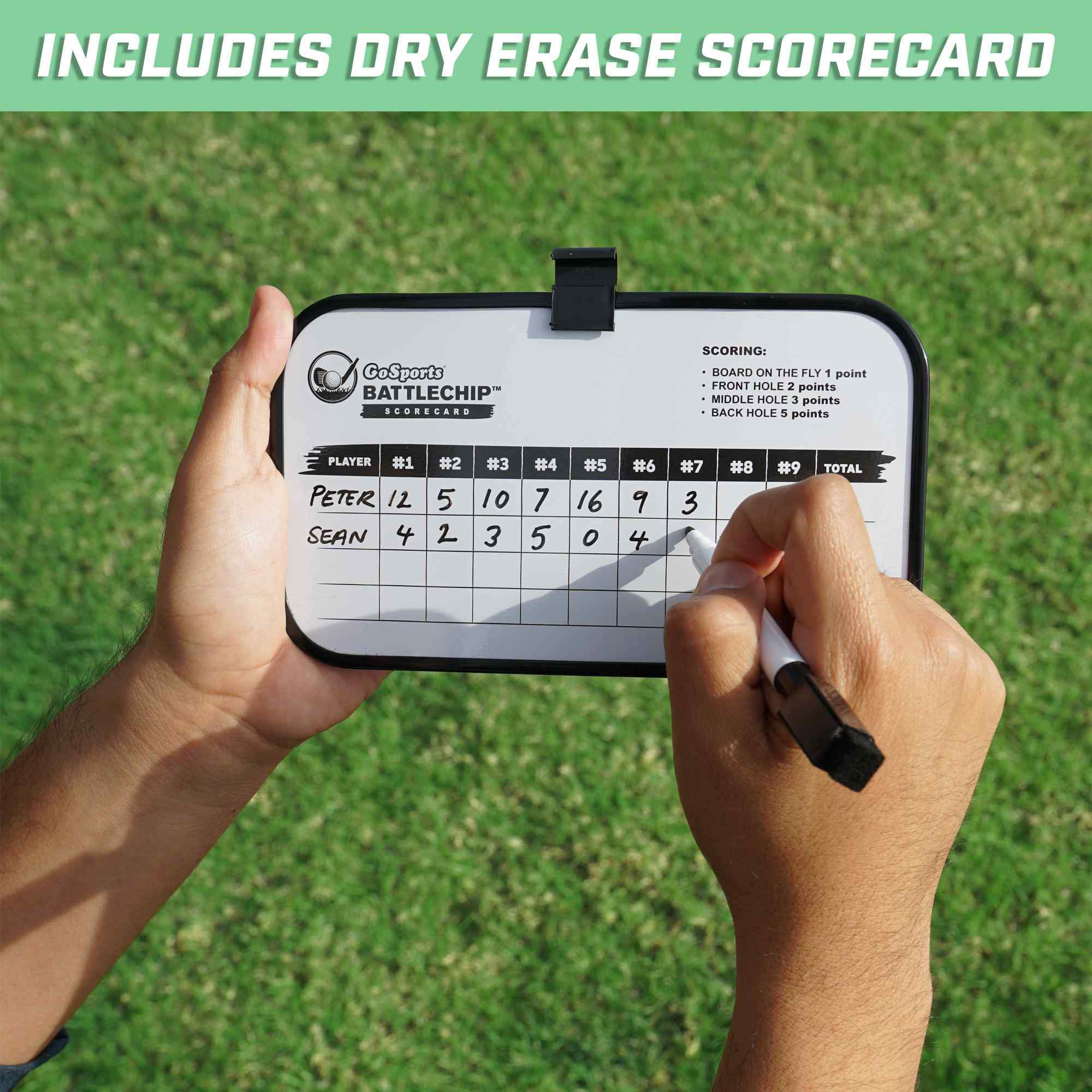 a person holding a cell phone with a score card