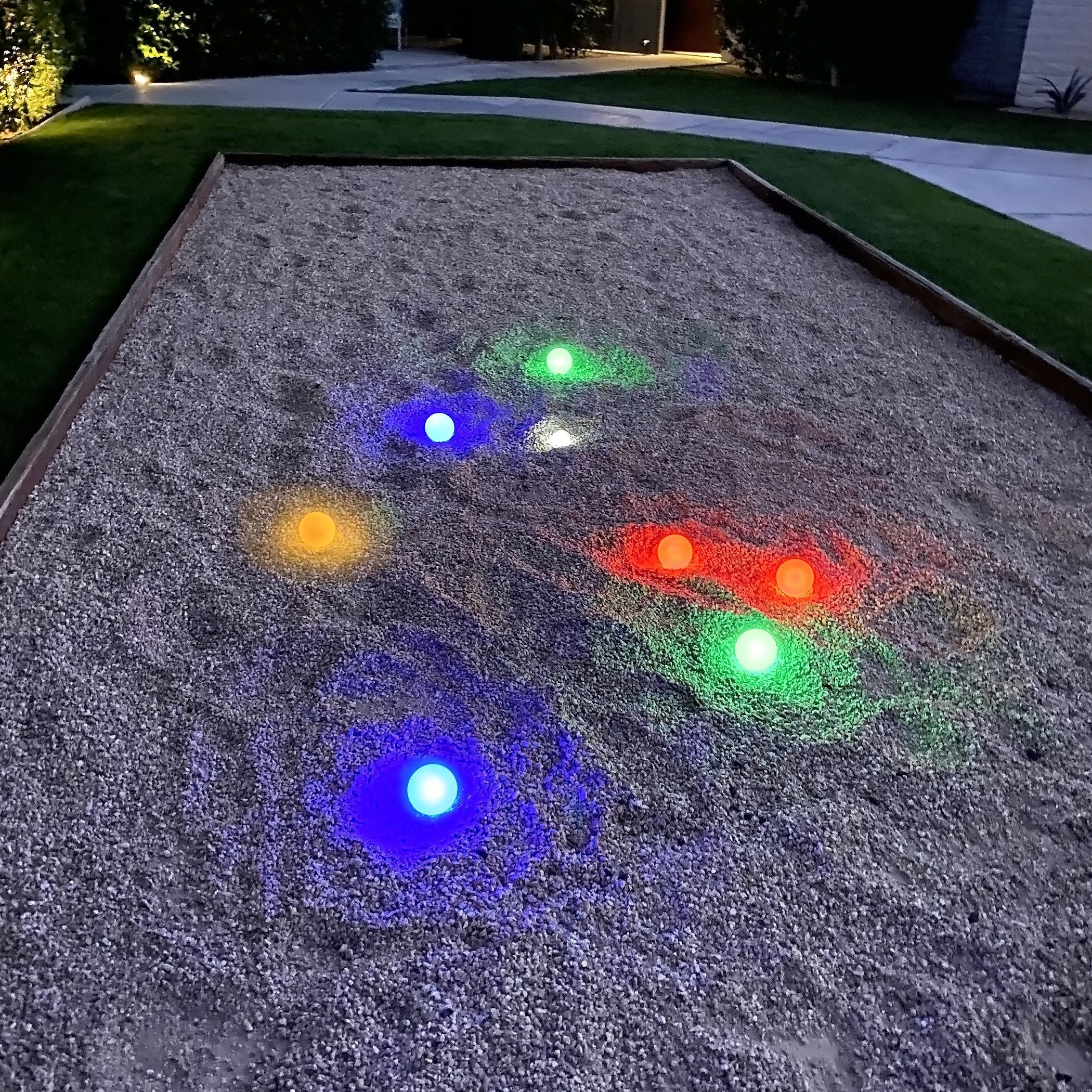 a garden with lights on the ground