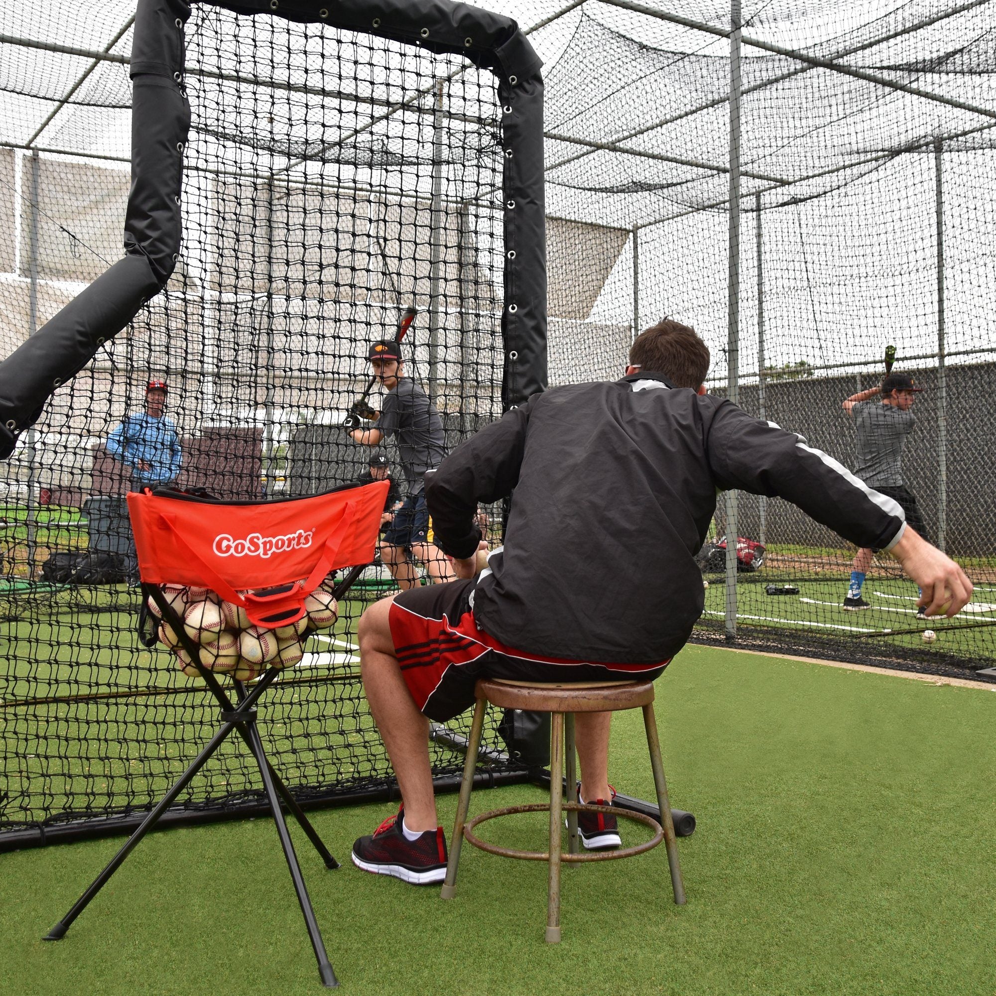 a man is practicing his swing in a batting cage