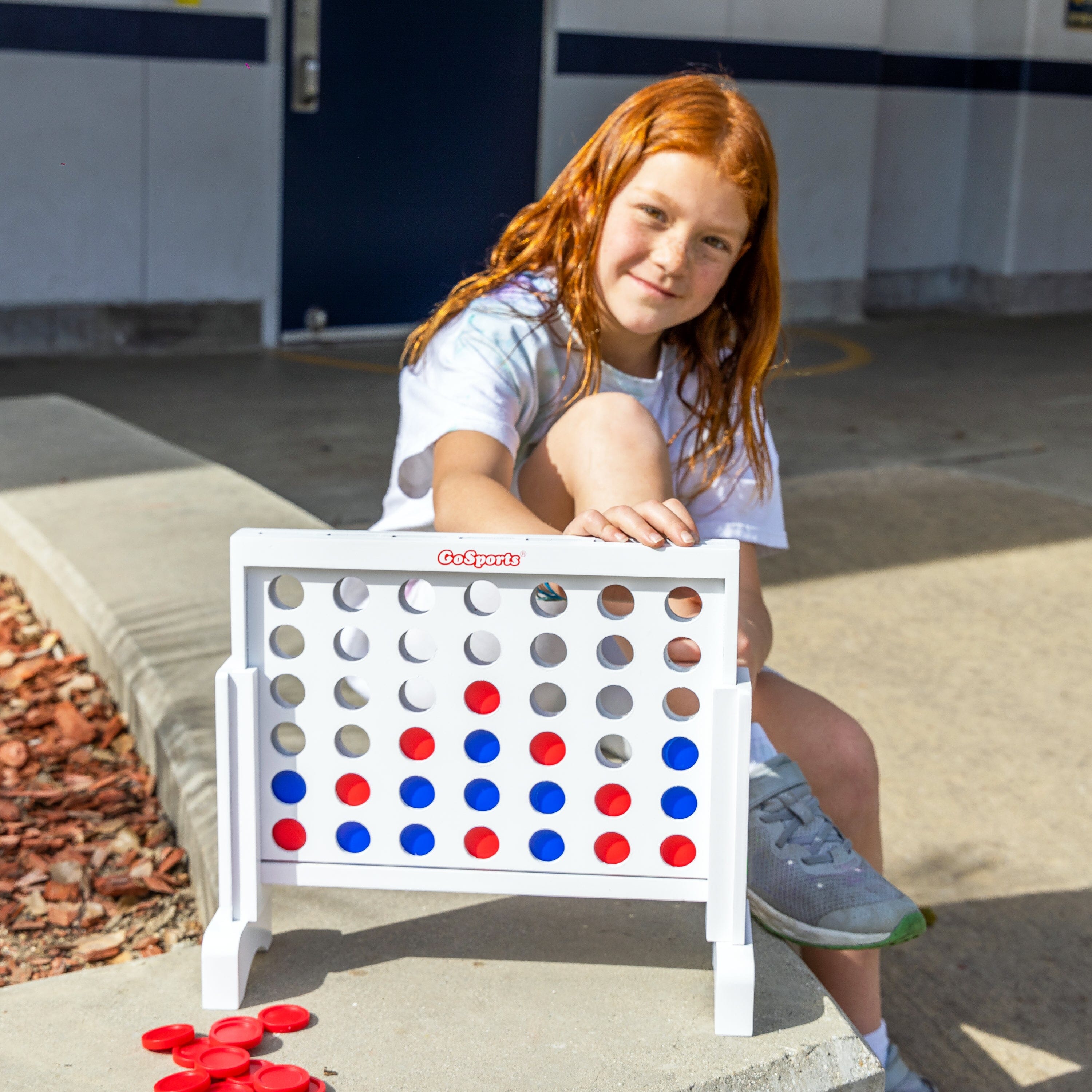 a girl sitting on a bench