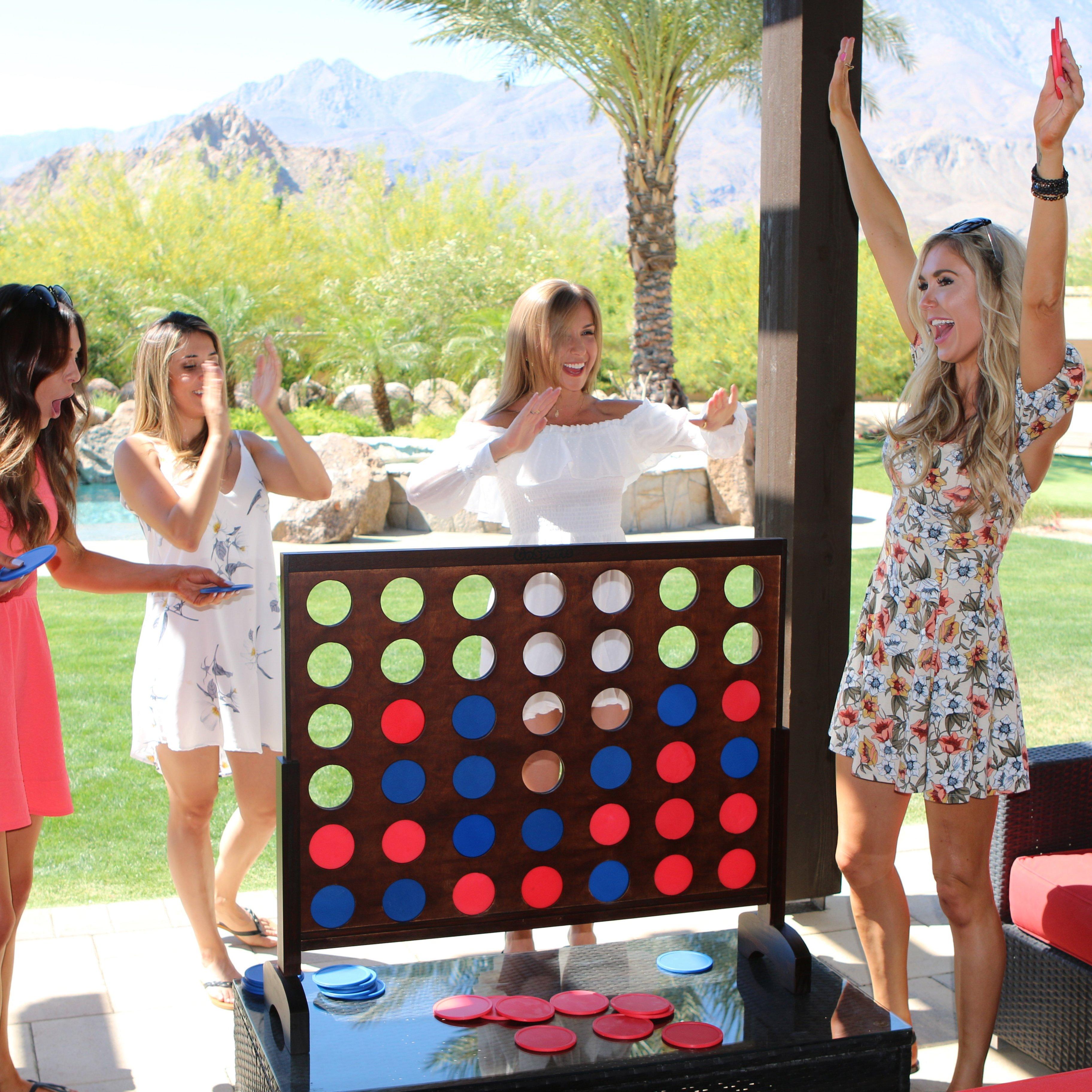 a group of women playing a game on a giant board