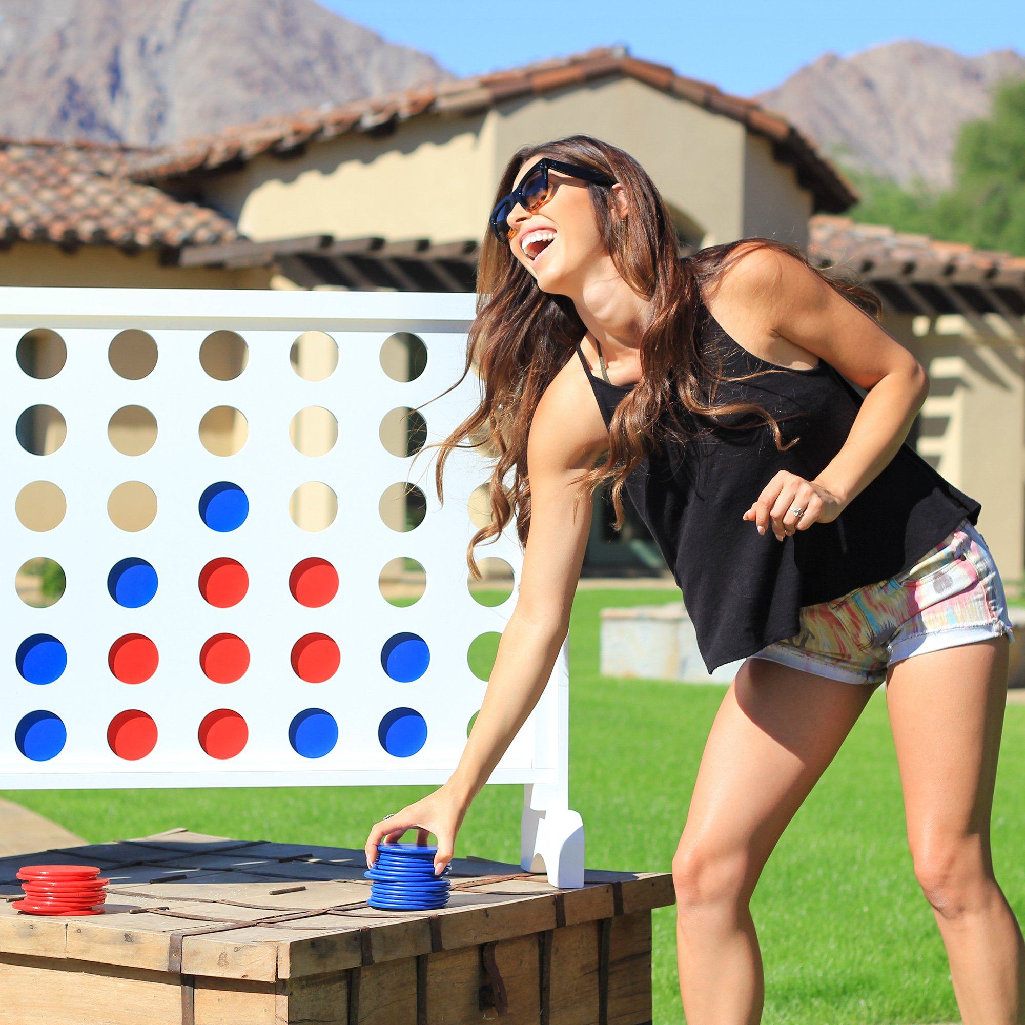 a woman playing with a giant connect the dots game