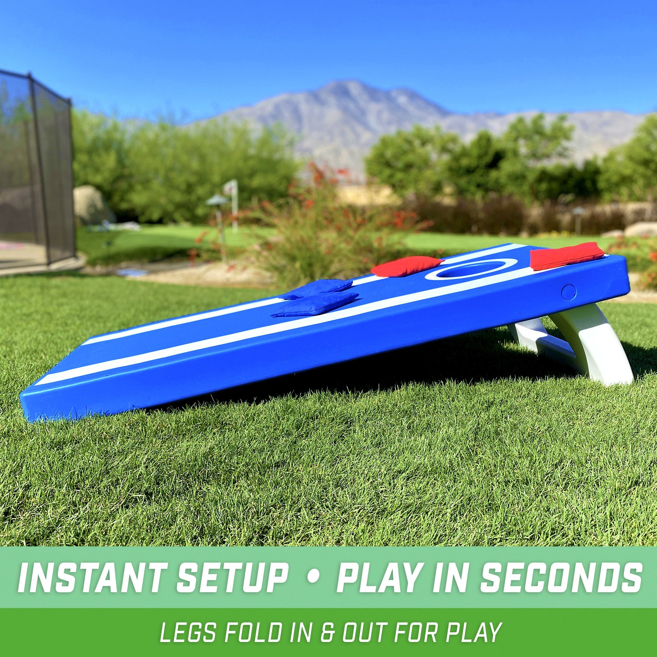 a blue and white plastic toy airplane sitting on the grass
