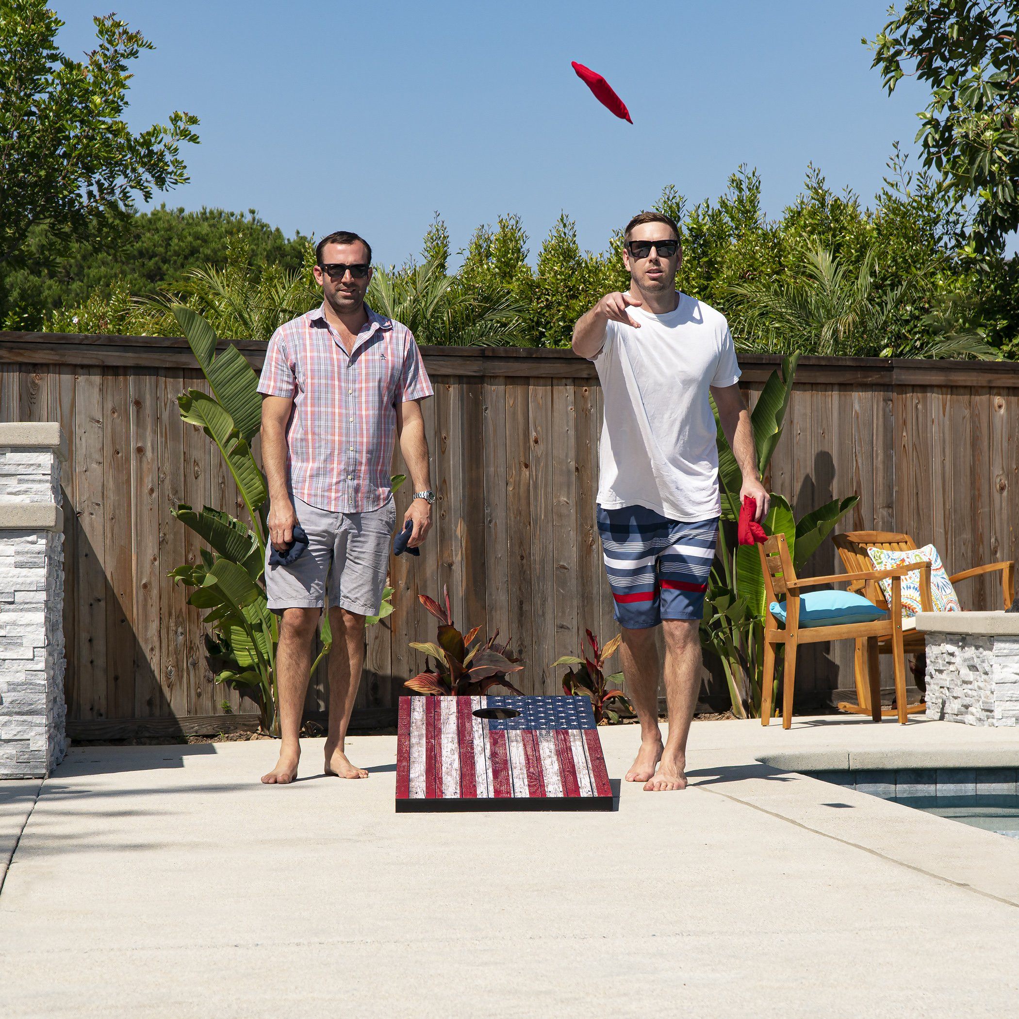 a man and a woman playing frosh in a backyard pool