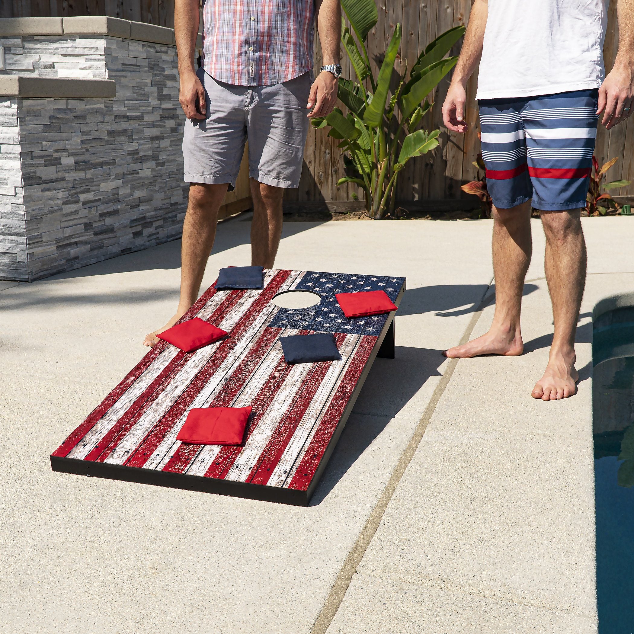 a man standing next to a pool with a flag on it