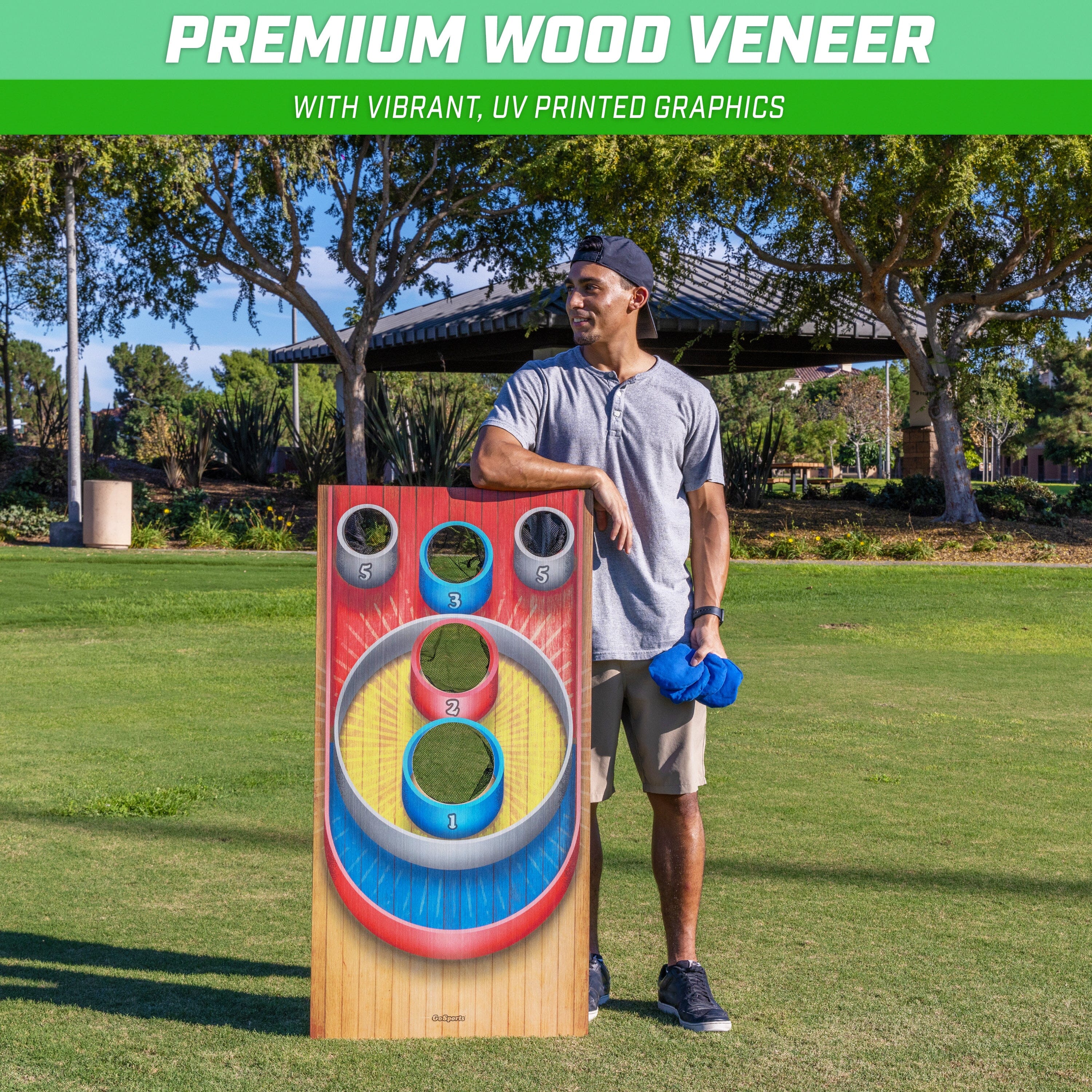 a man standing next to a giant wooden game