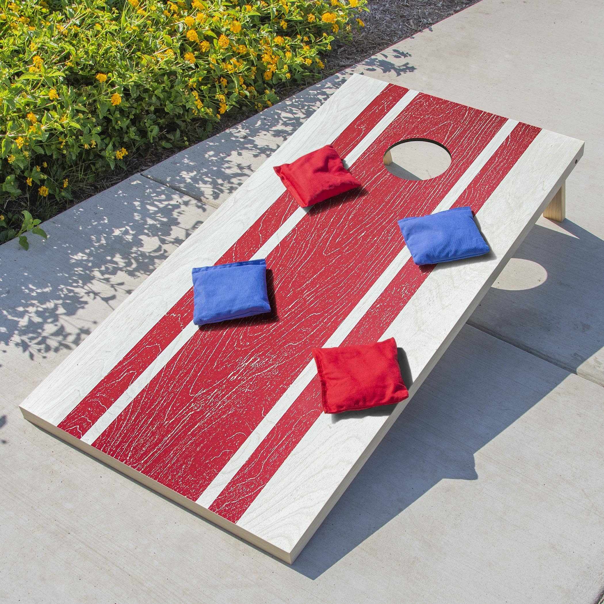 a wooden corno game set with red and white stripes