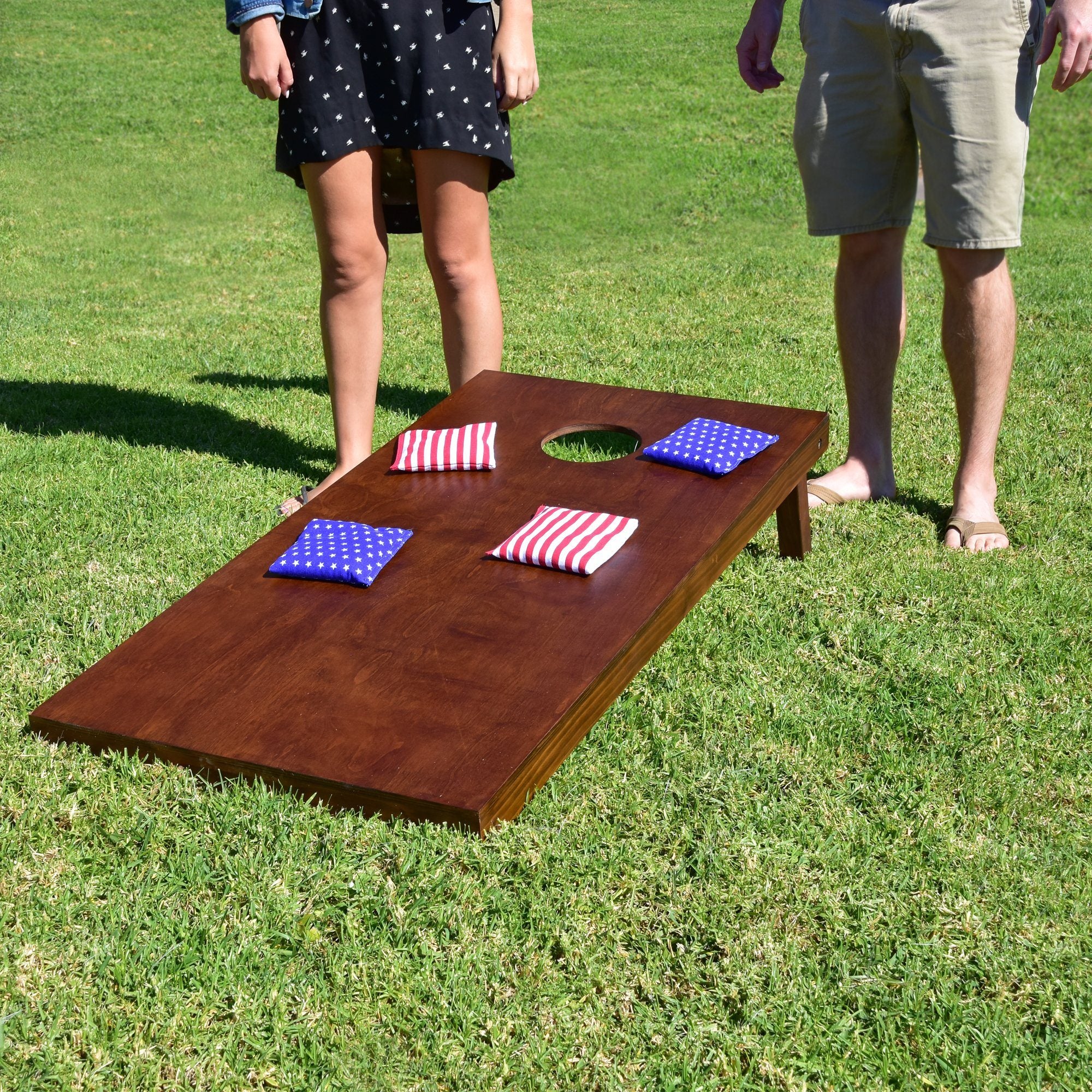 a man and a woman playing a game of corn corn