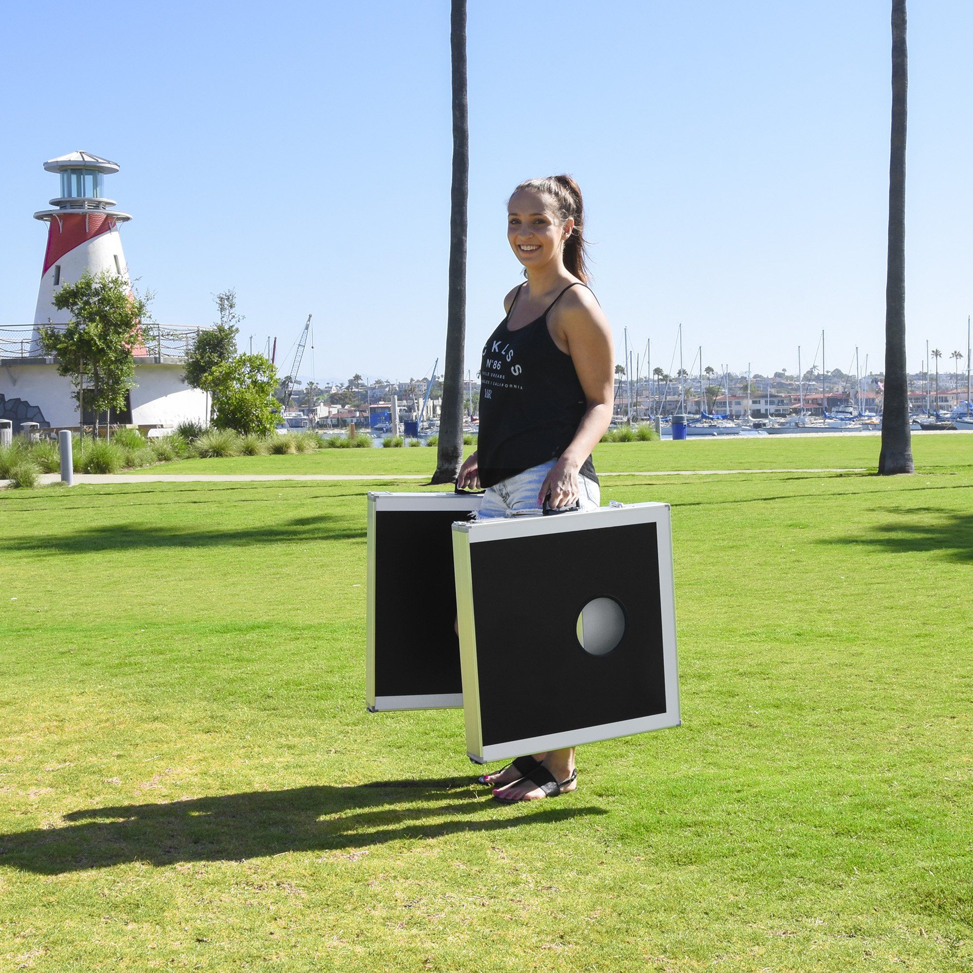 a woman holding a laptop in a park