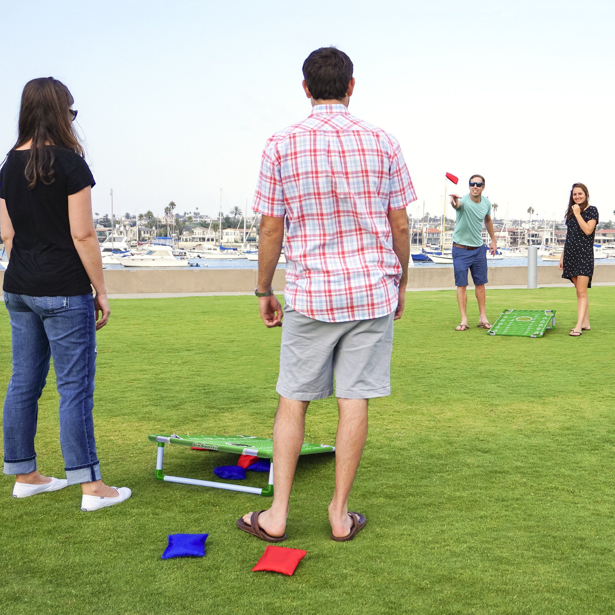 a group of people standing around a field