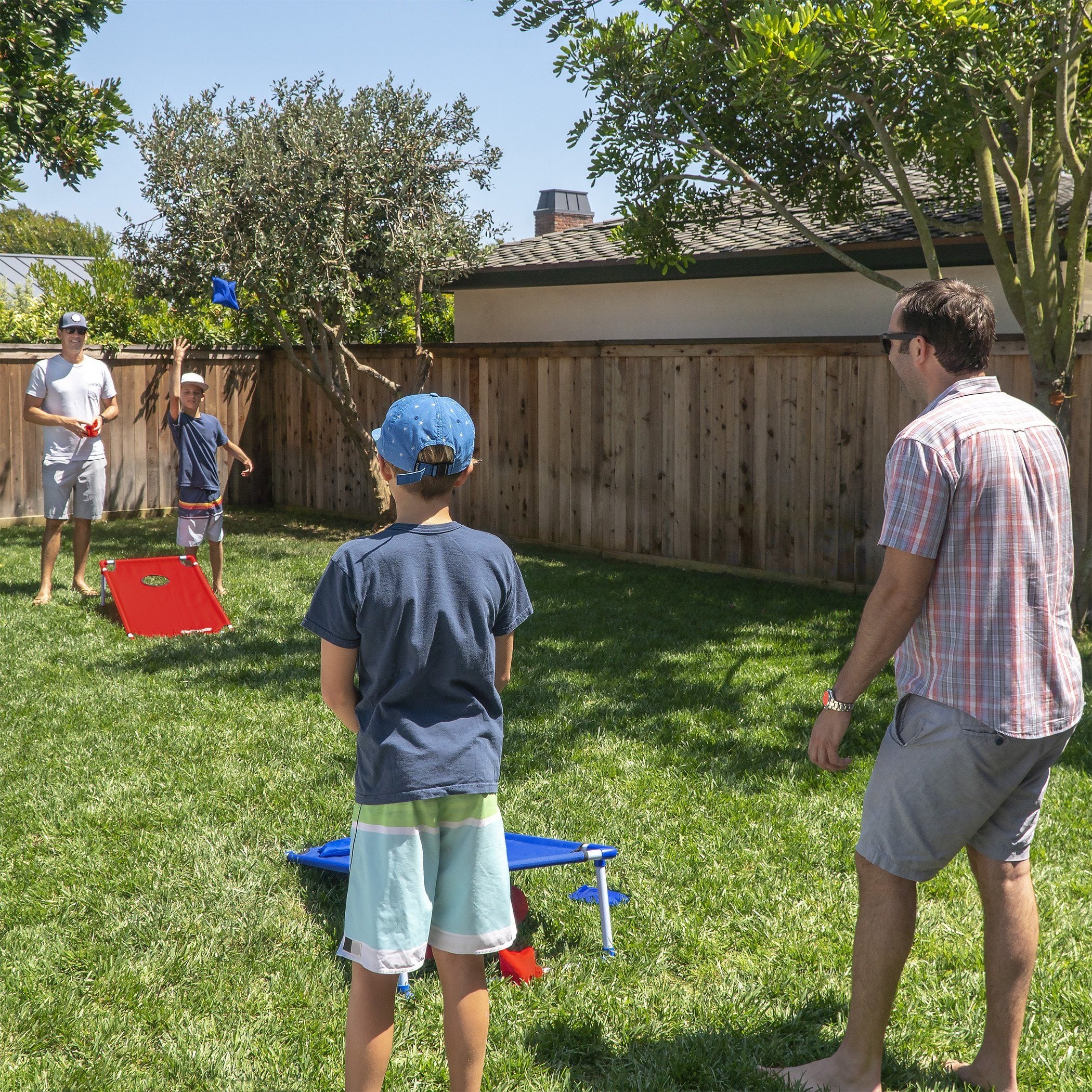 a group of people playing frng in the yard