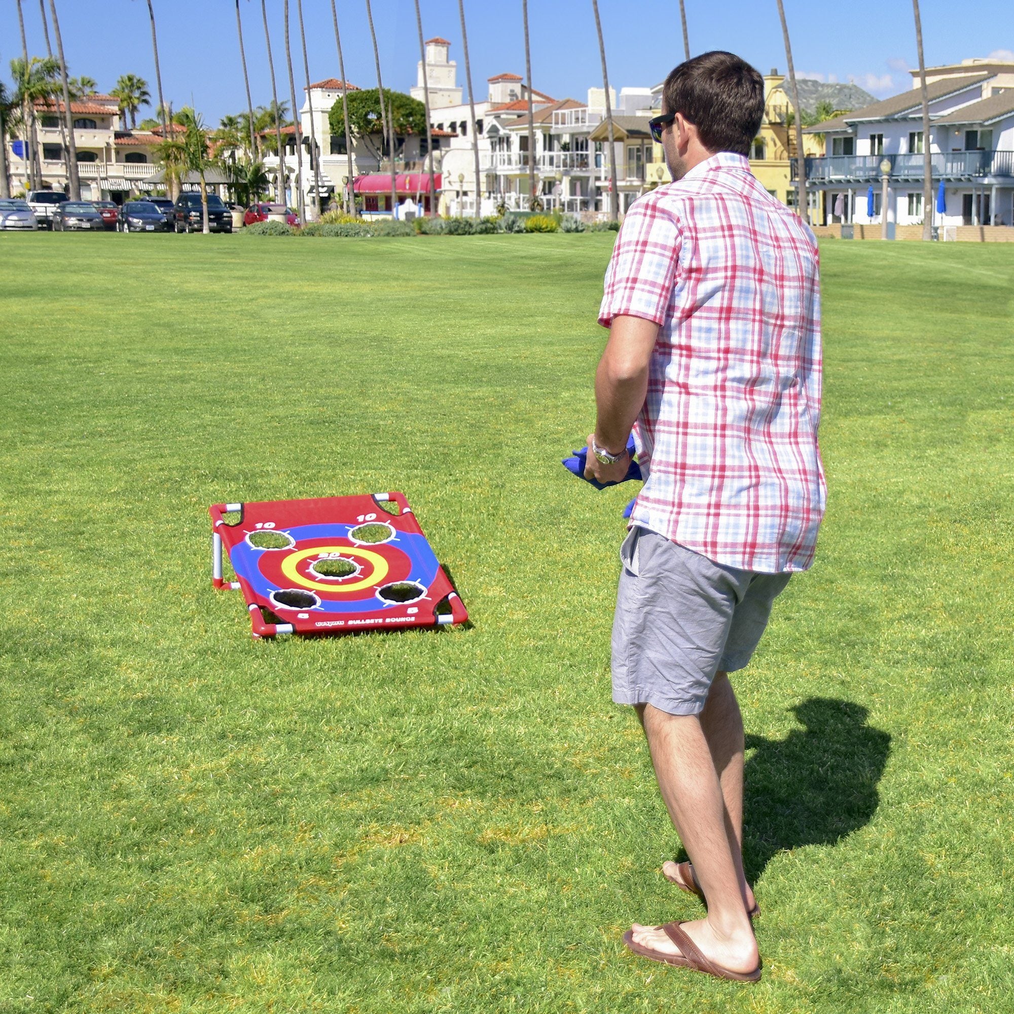 a man is playing with a kite in the grass