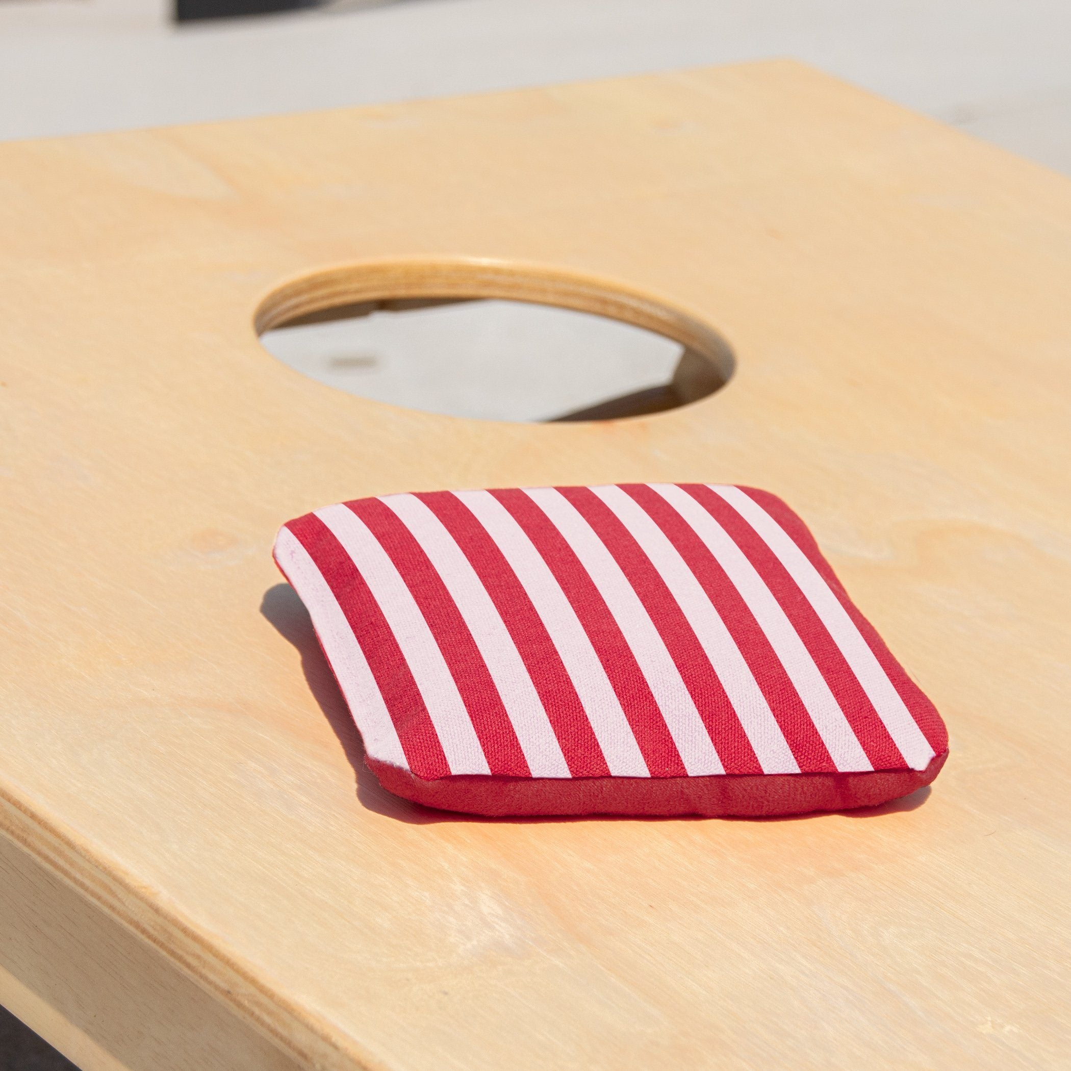 a red and white striped cloth on a wooden table