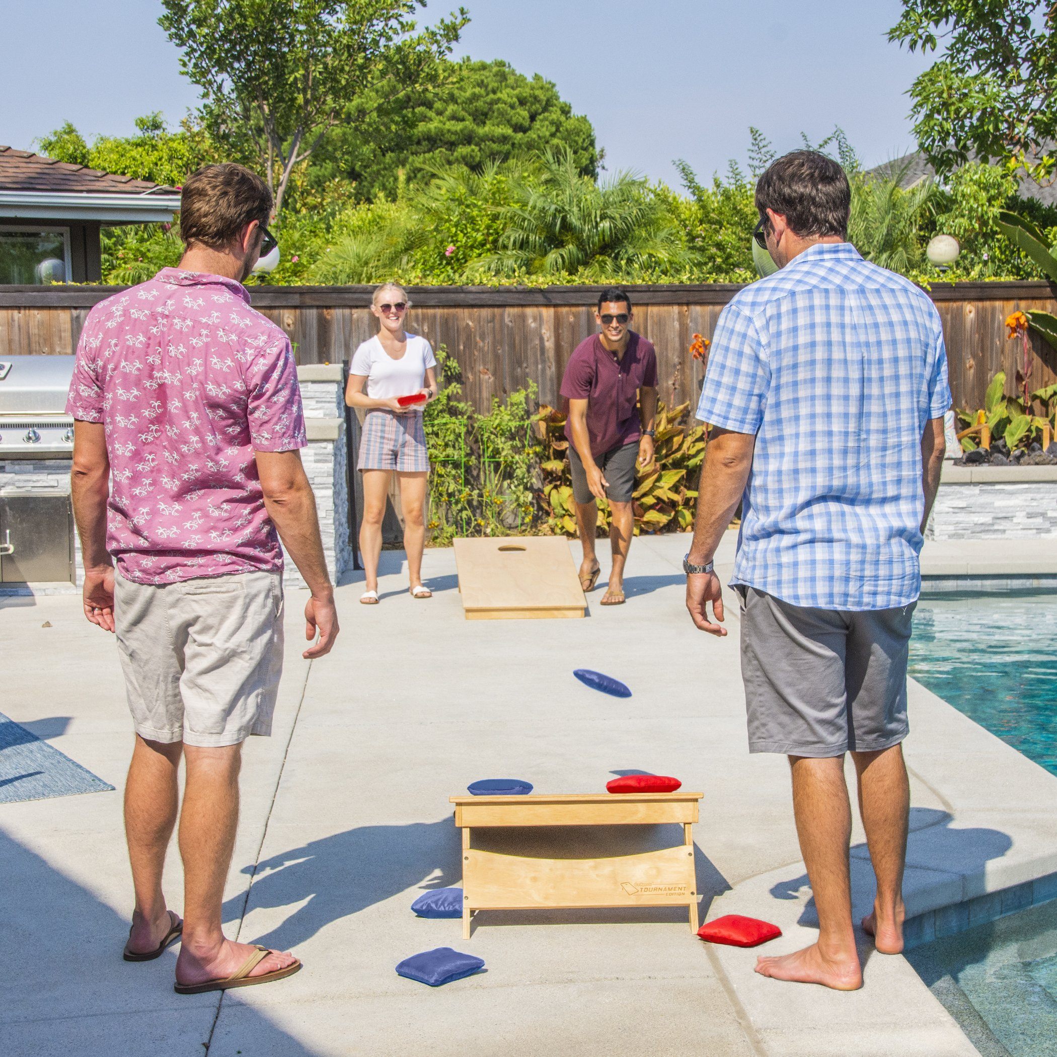 a group of people playing a game of cornhole