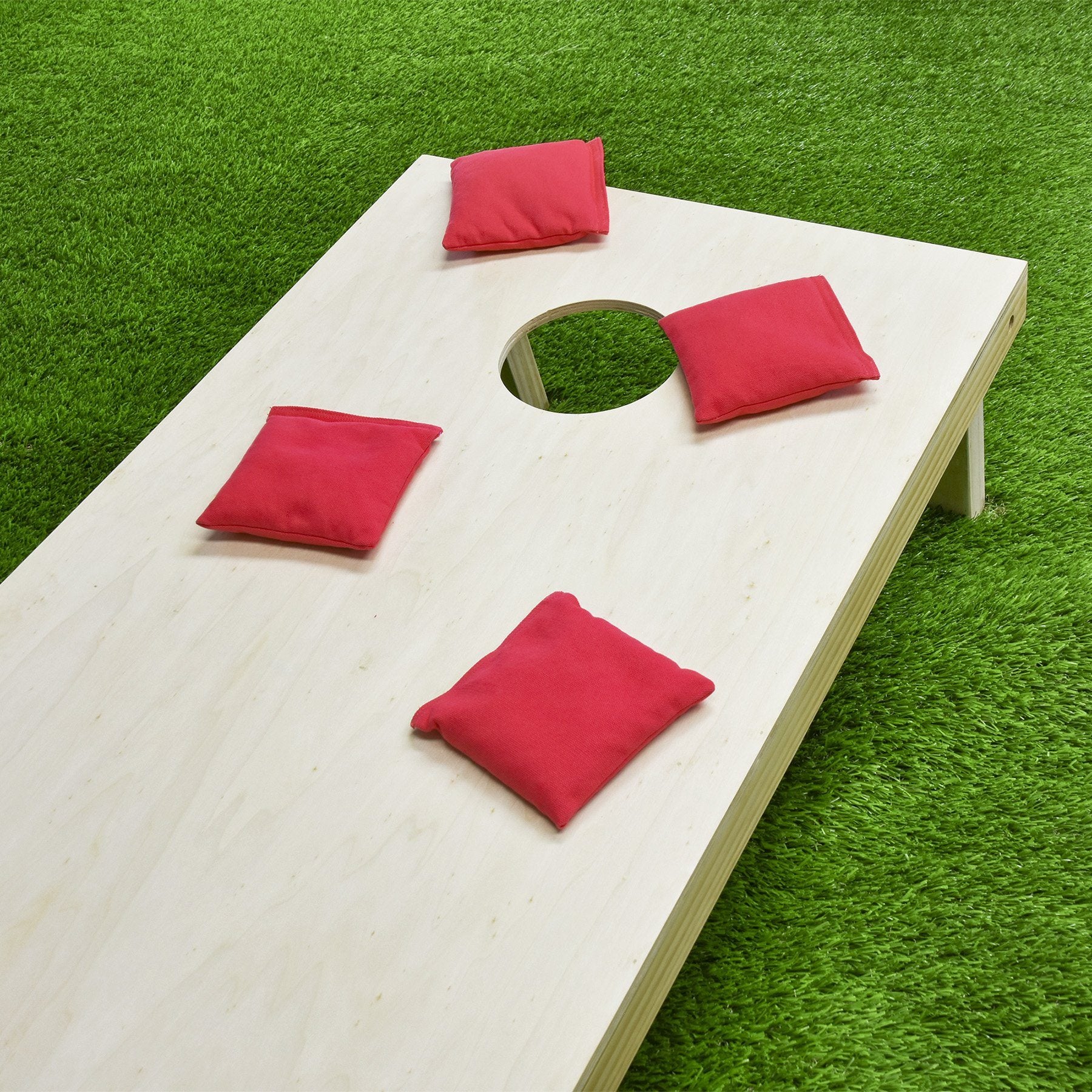 a wooden table with red pillows on it