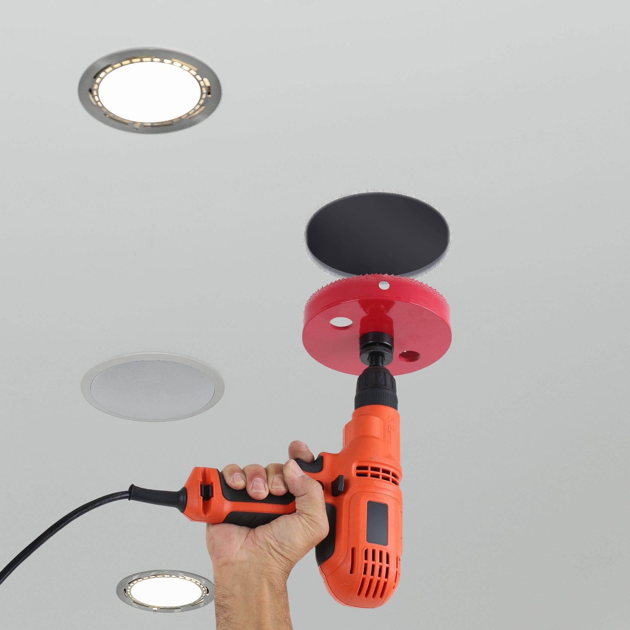 a person holding a driller in their hand