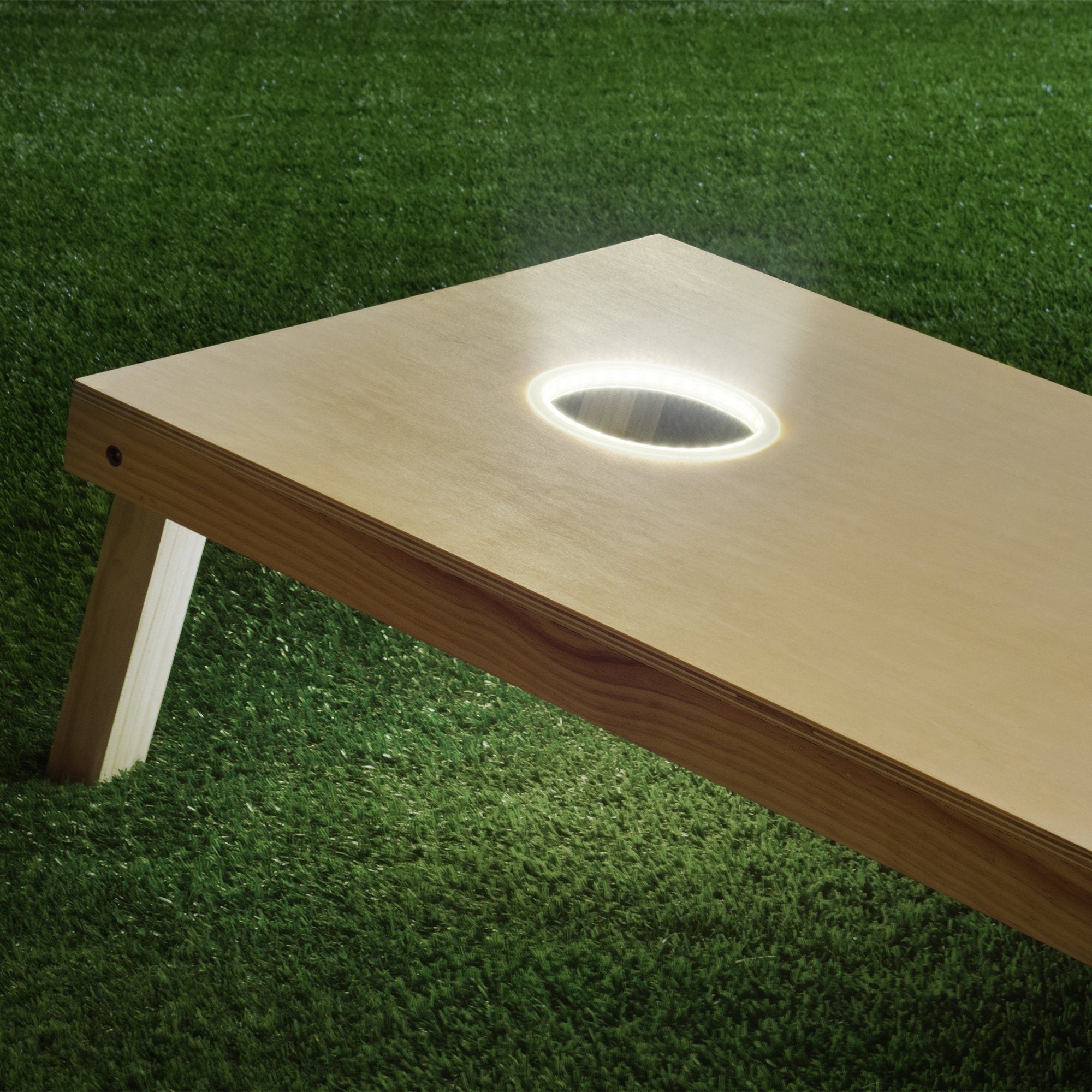 a wooden table with a lit hole in the middle