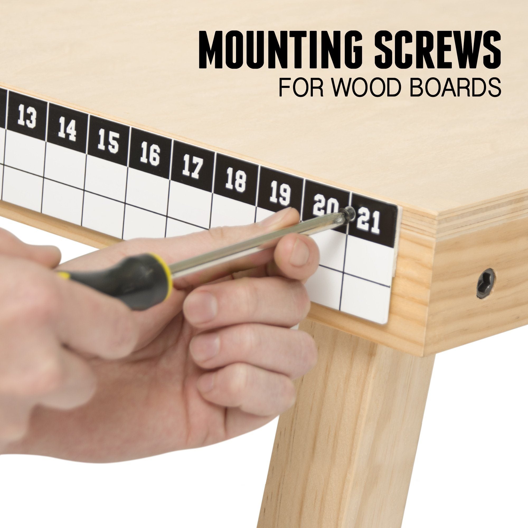 a person using a ruler to measure the width of a wooden table