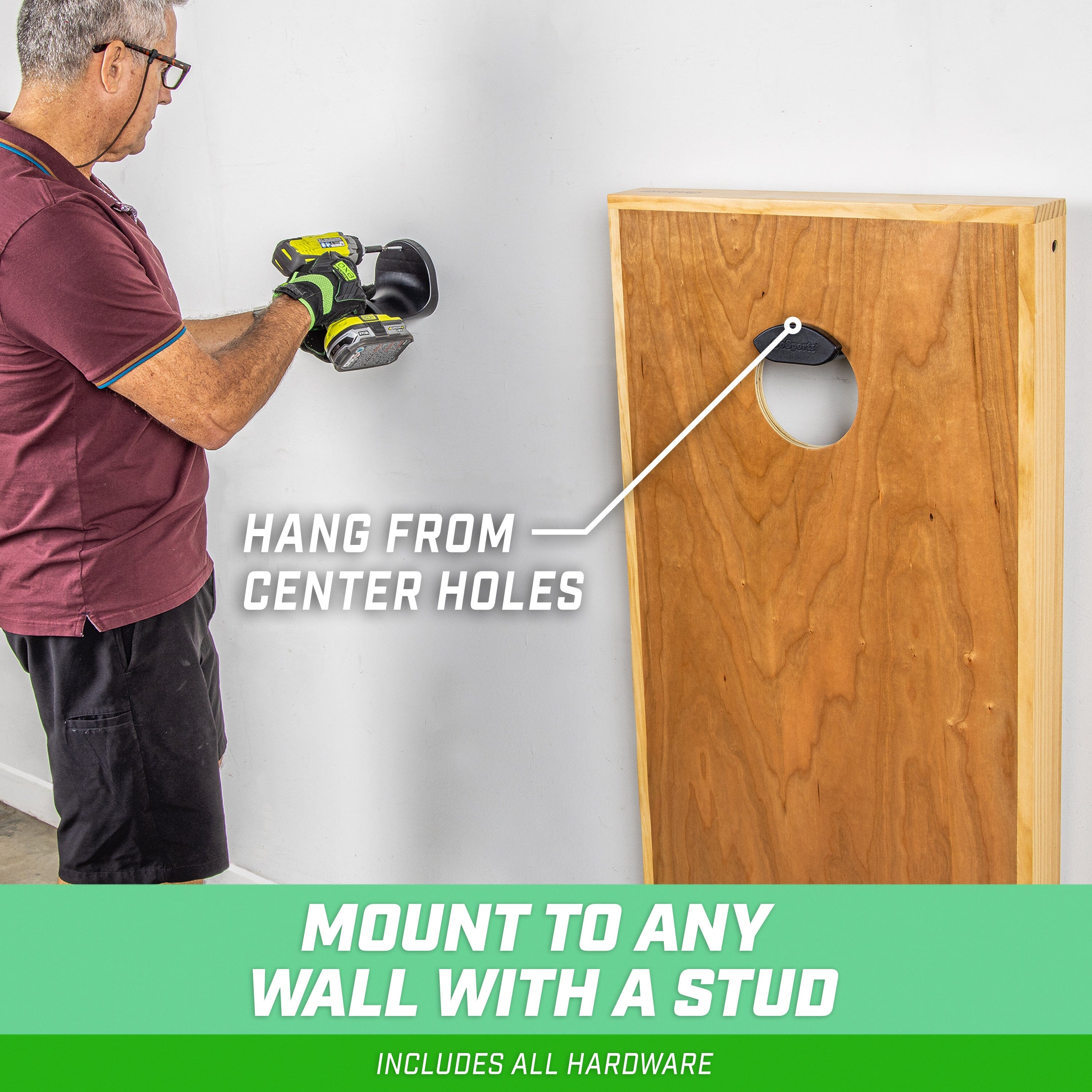 a man using a drill gun to drill holes in a wall