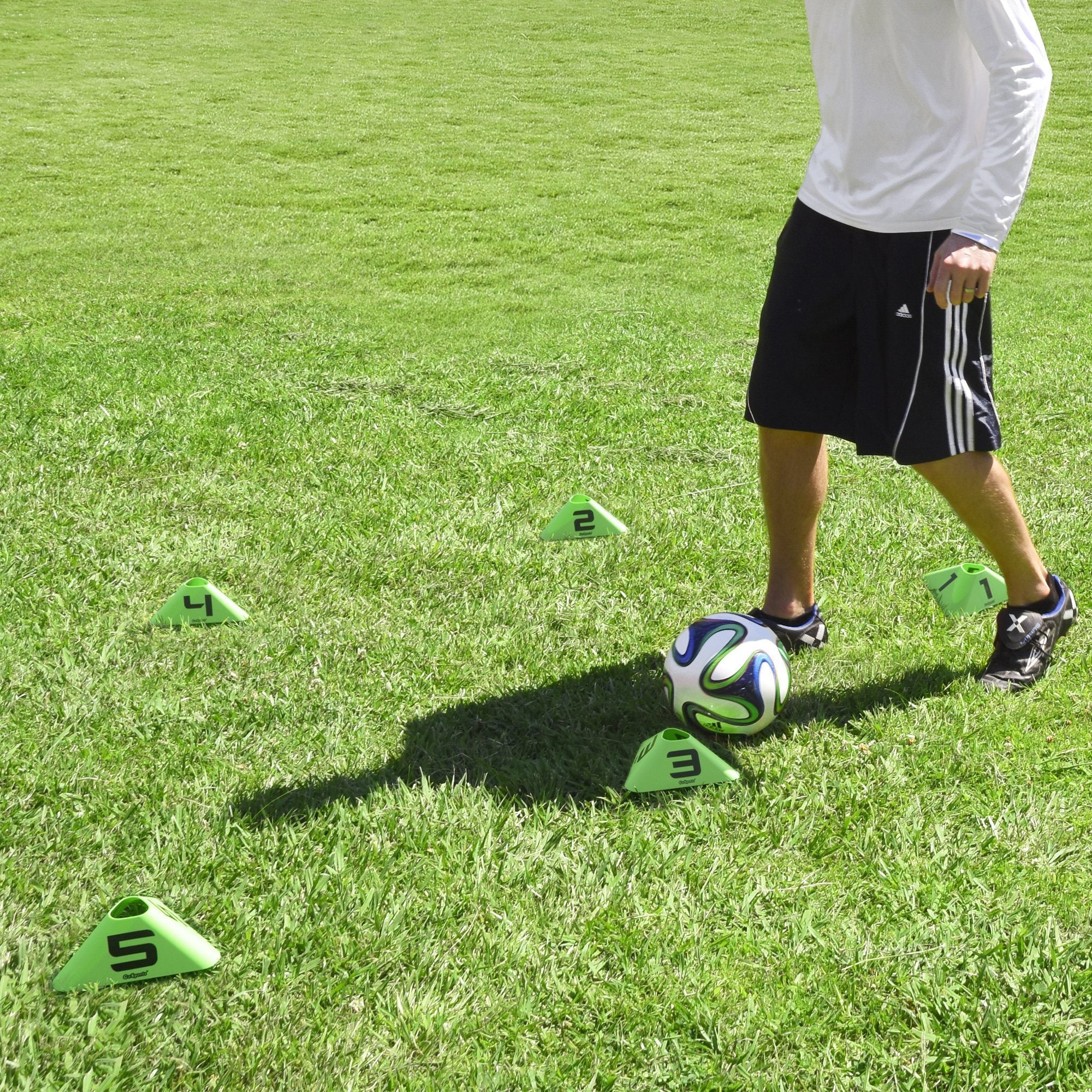 a young boy is playing soccer on the grass