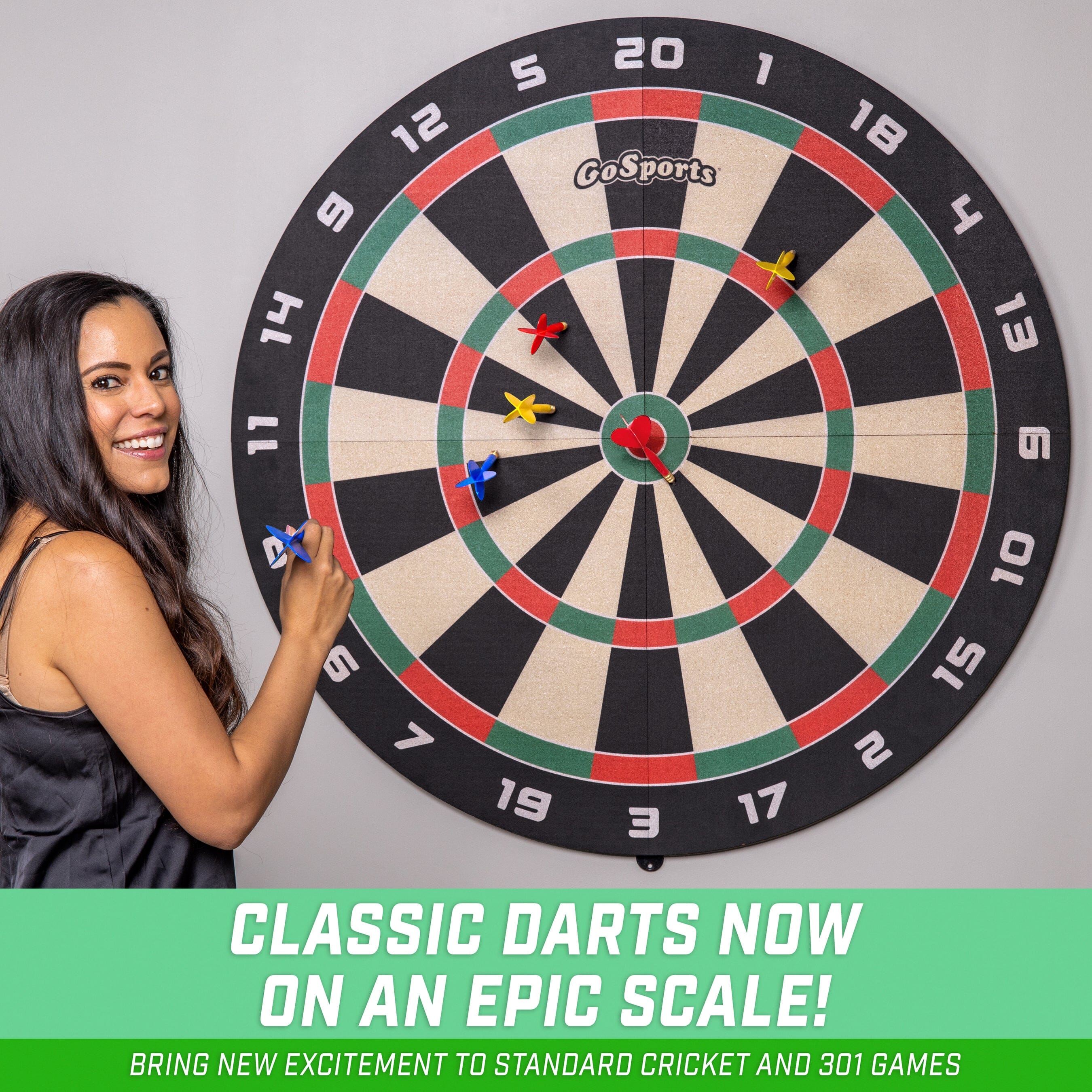 a woman holding a dart in front of a dart