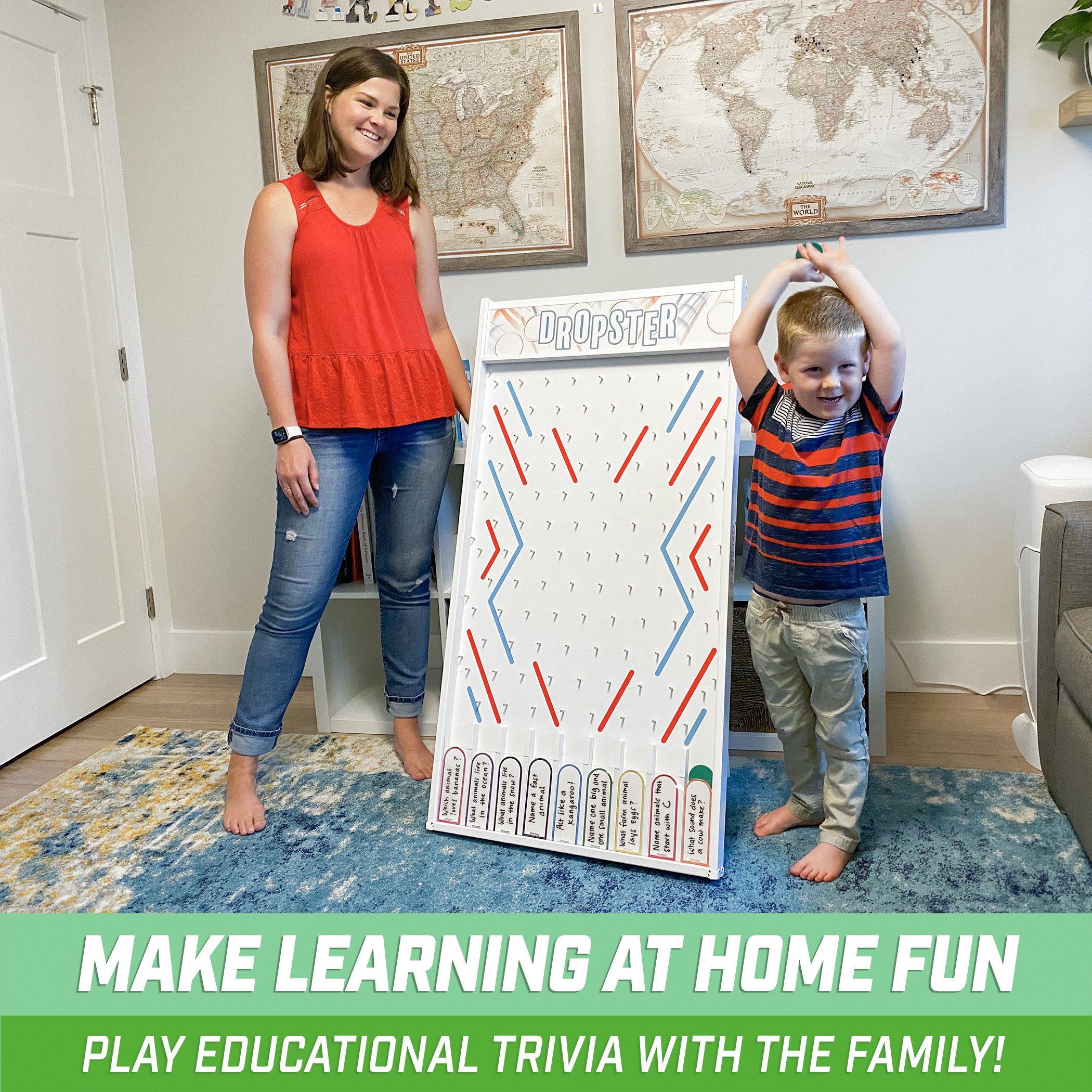 a woman and a child standing in front of a giant board game