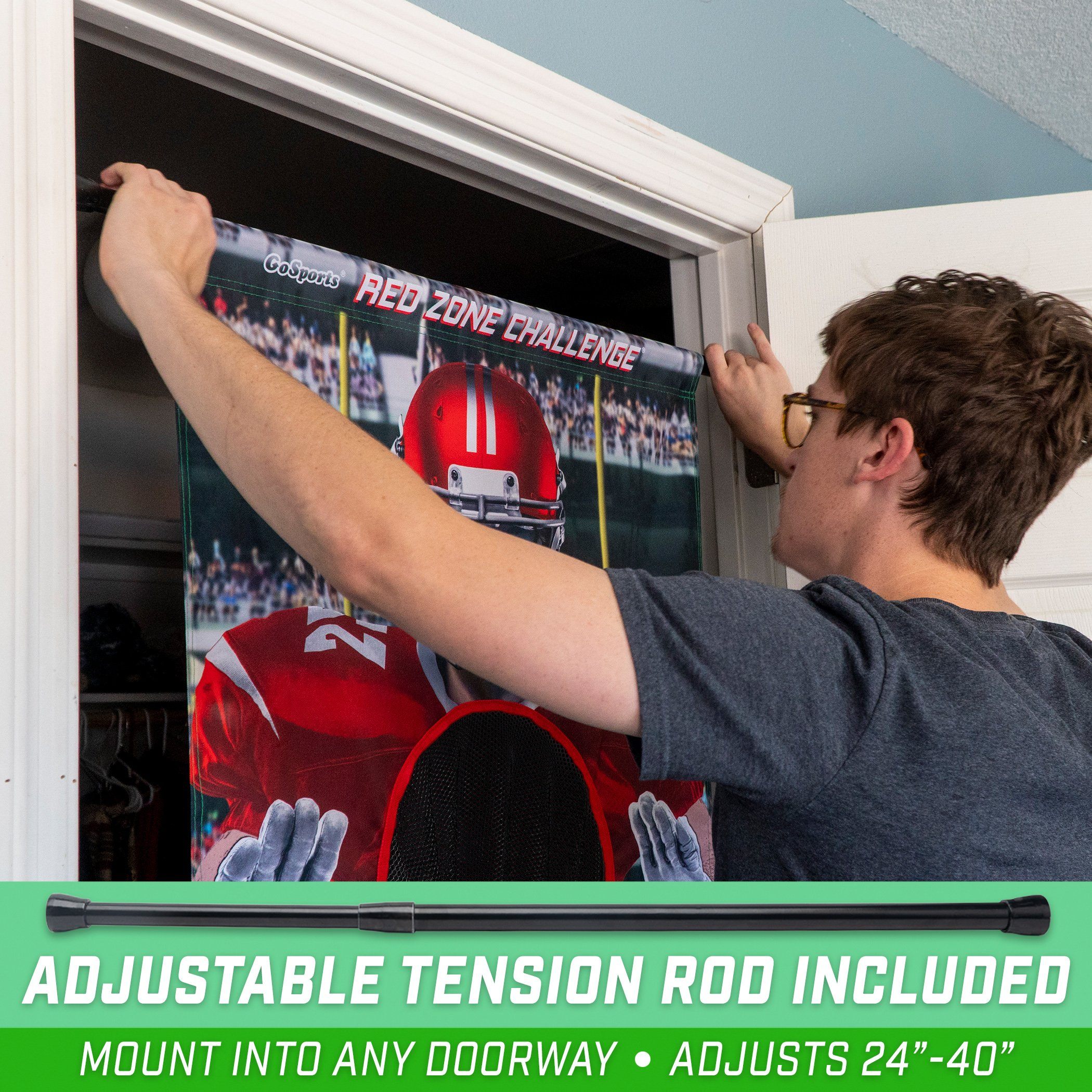 a man is putting a football poster on the wall