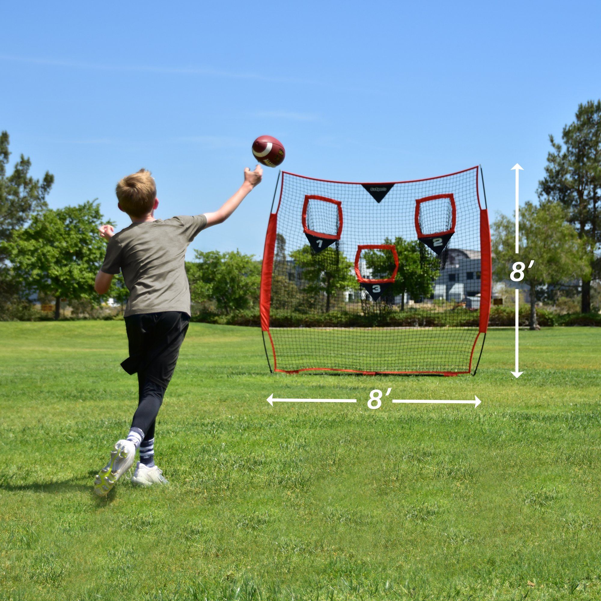 a boy throwing a football ball in a field