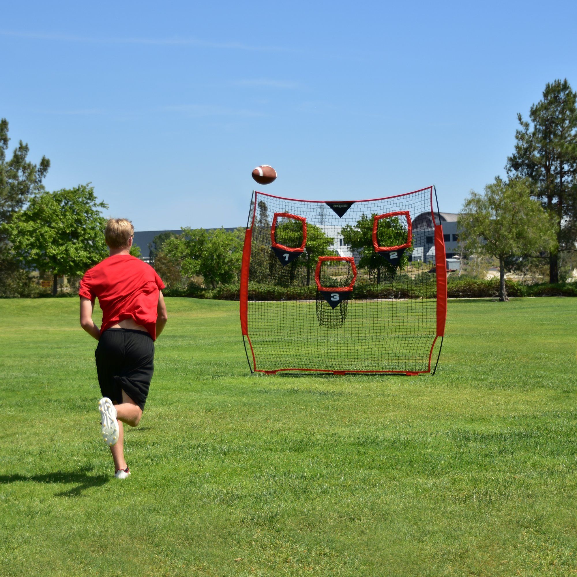 a boy running towards a soccer goal