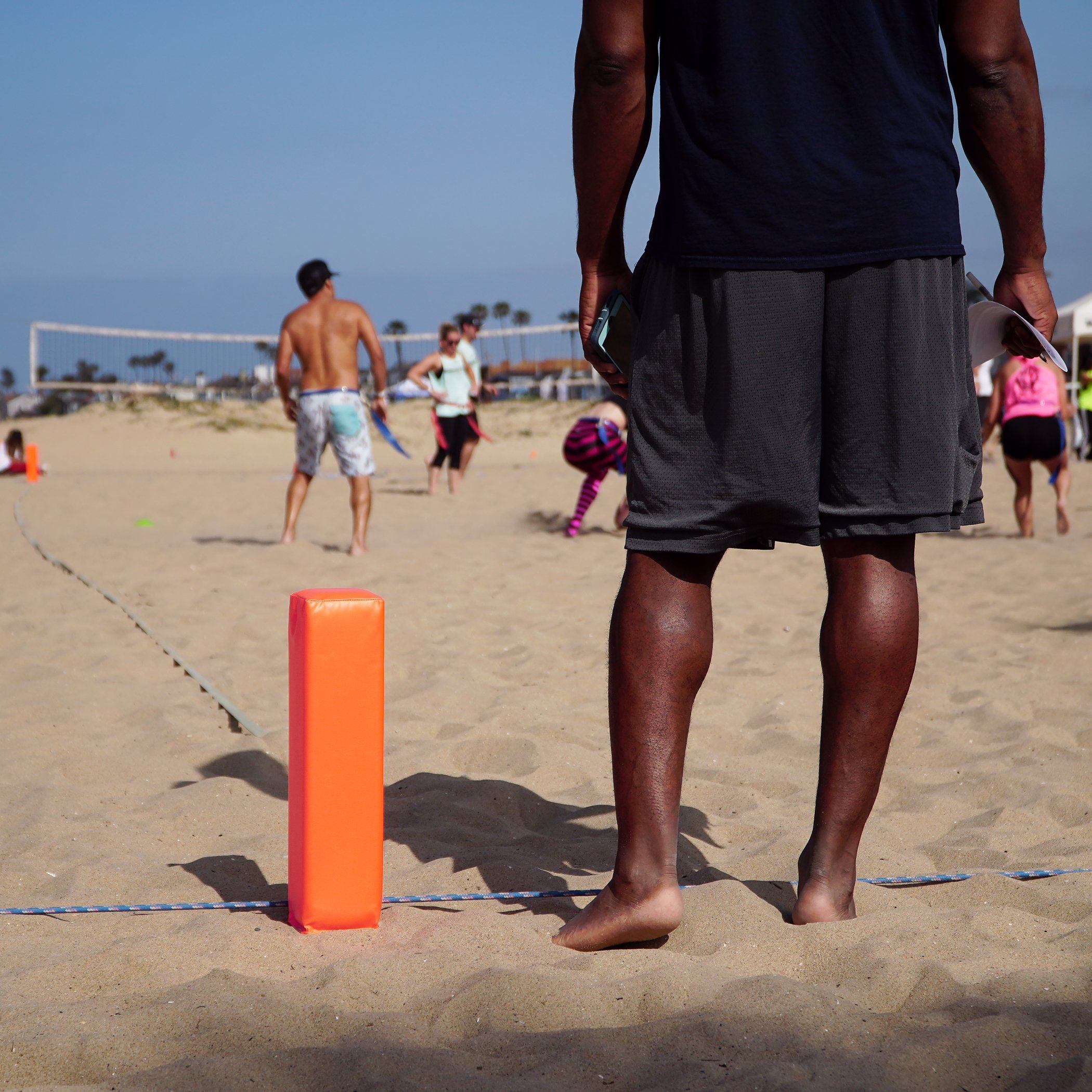 a man standing on a beach with a frc