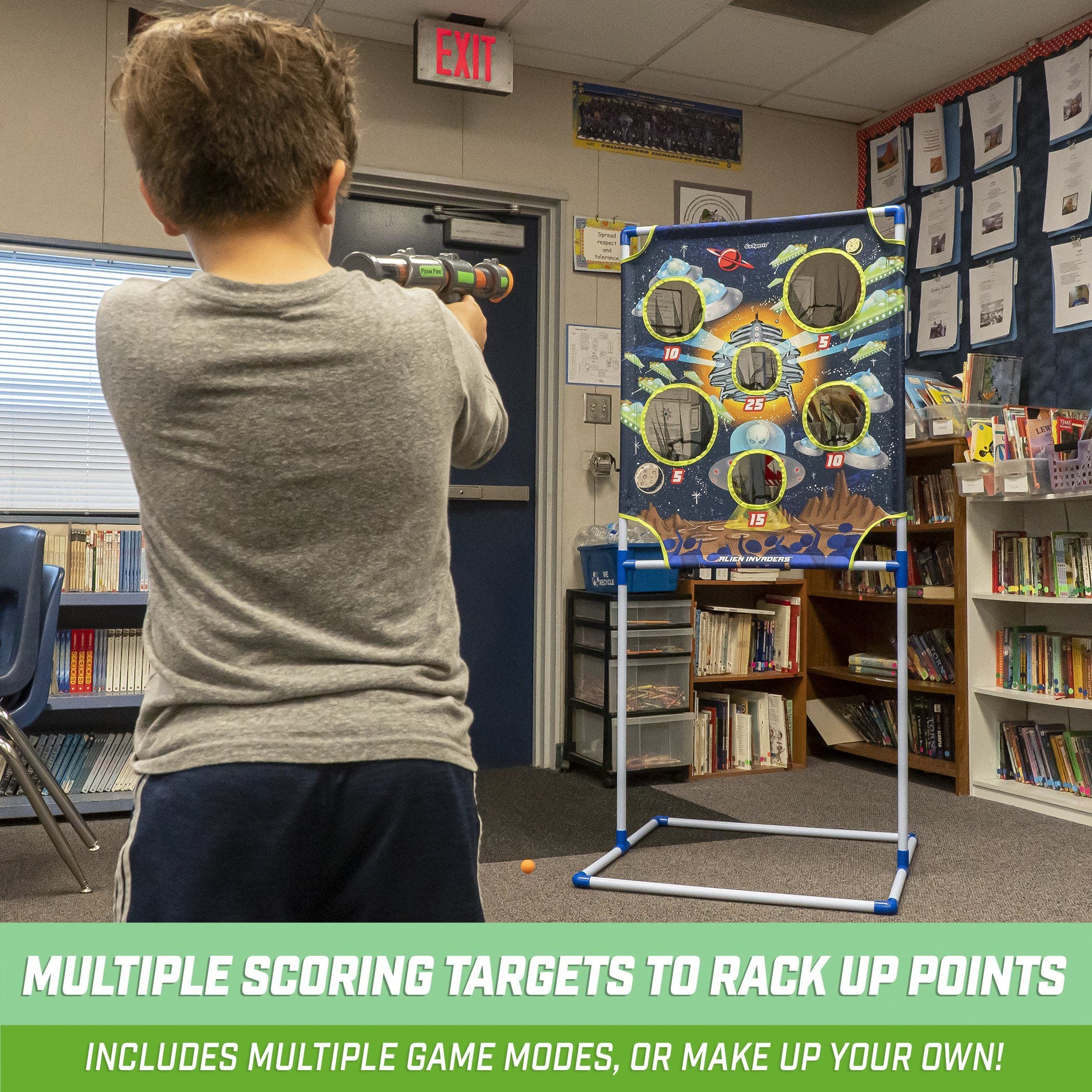 a boy is playing a video game in a classroom