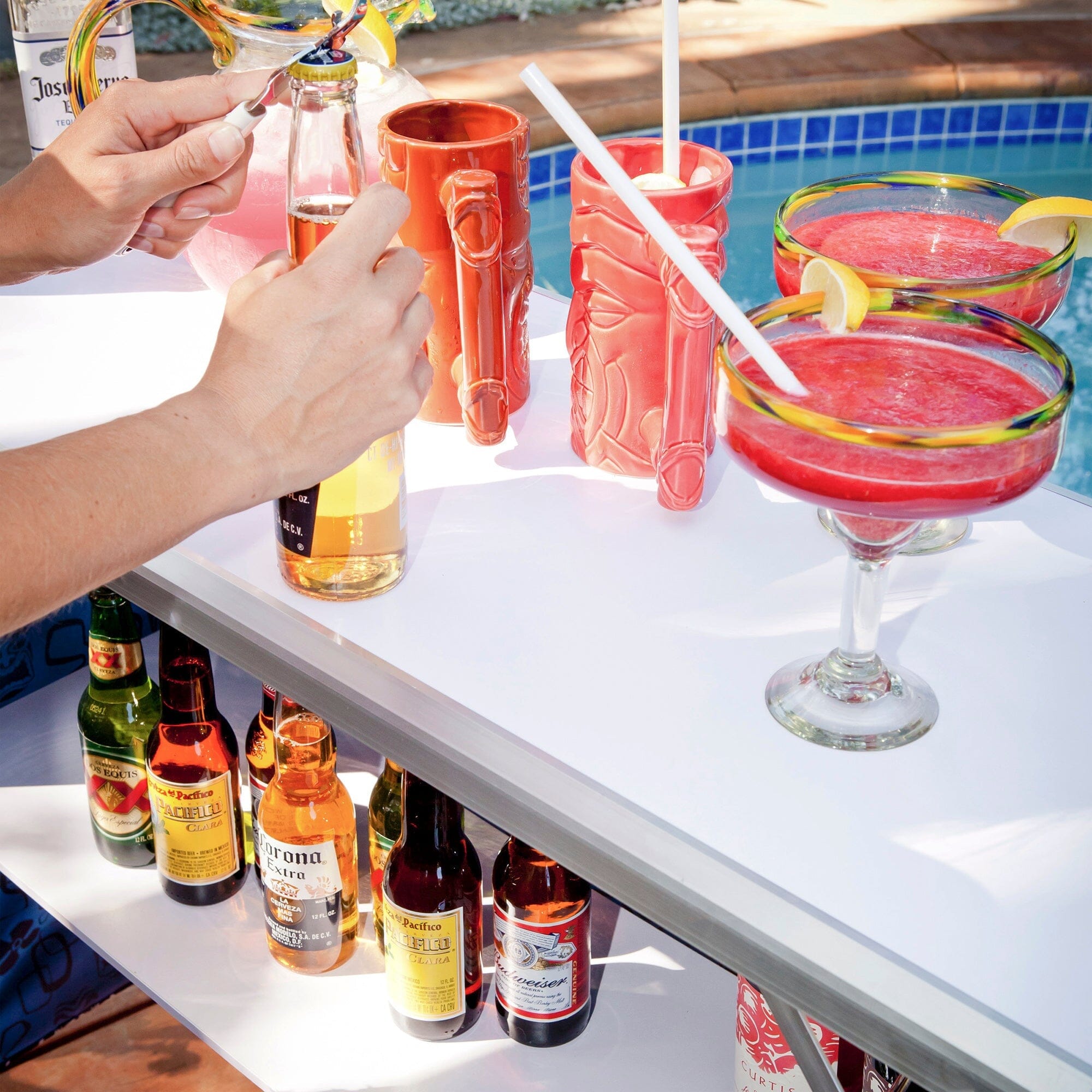 a man is pouring a drink into a glass