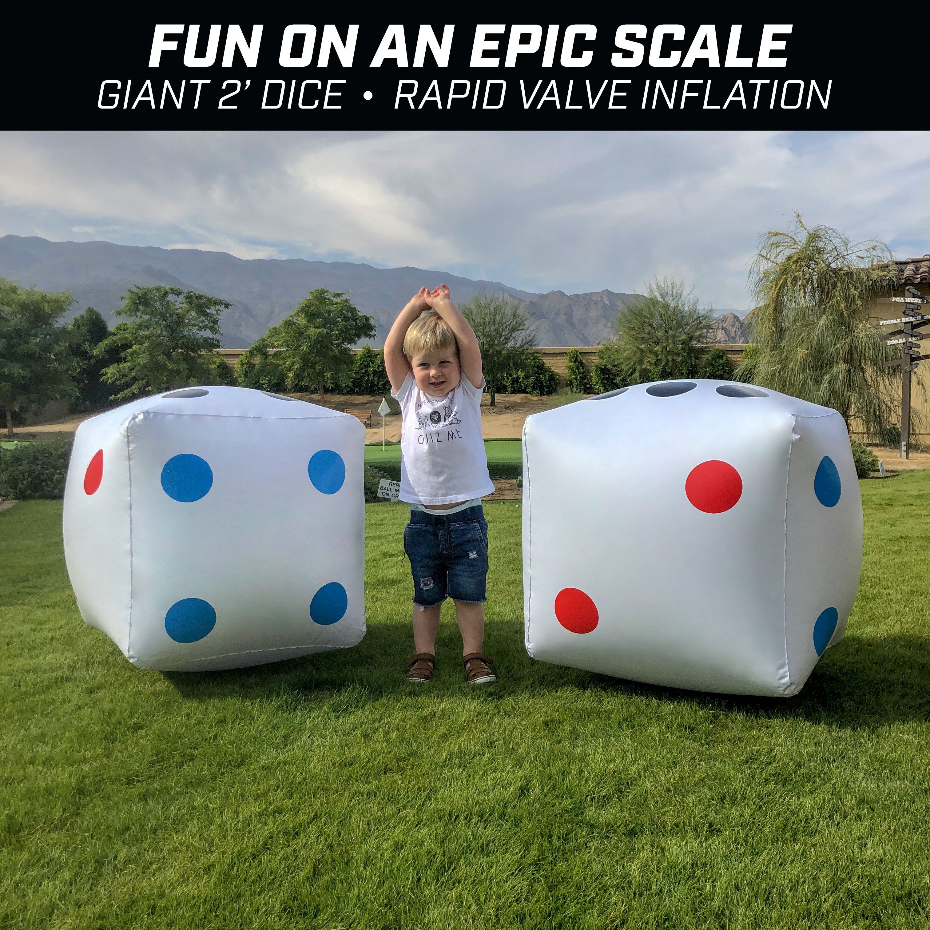 a young boy standing in front of a giant inflatable