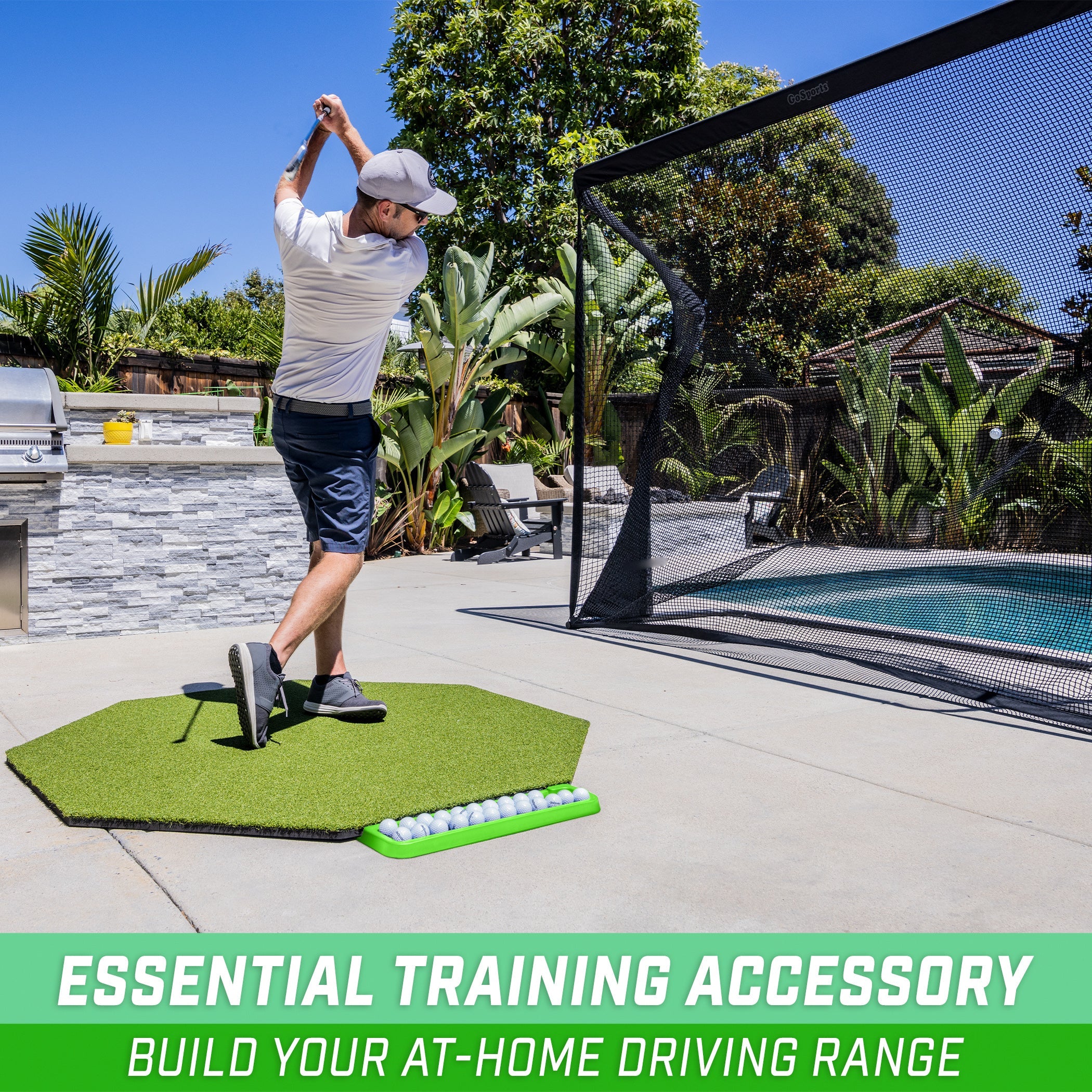 a man swinging a golf club ball on a golf mat